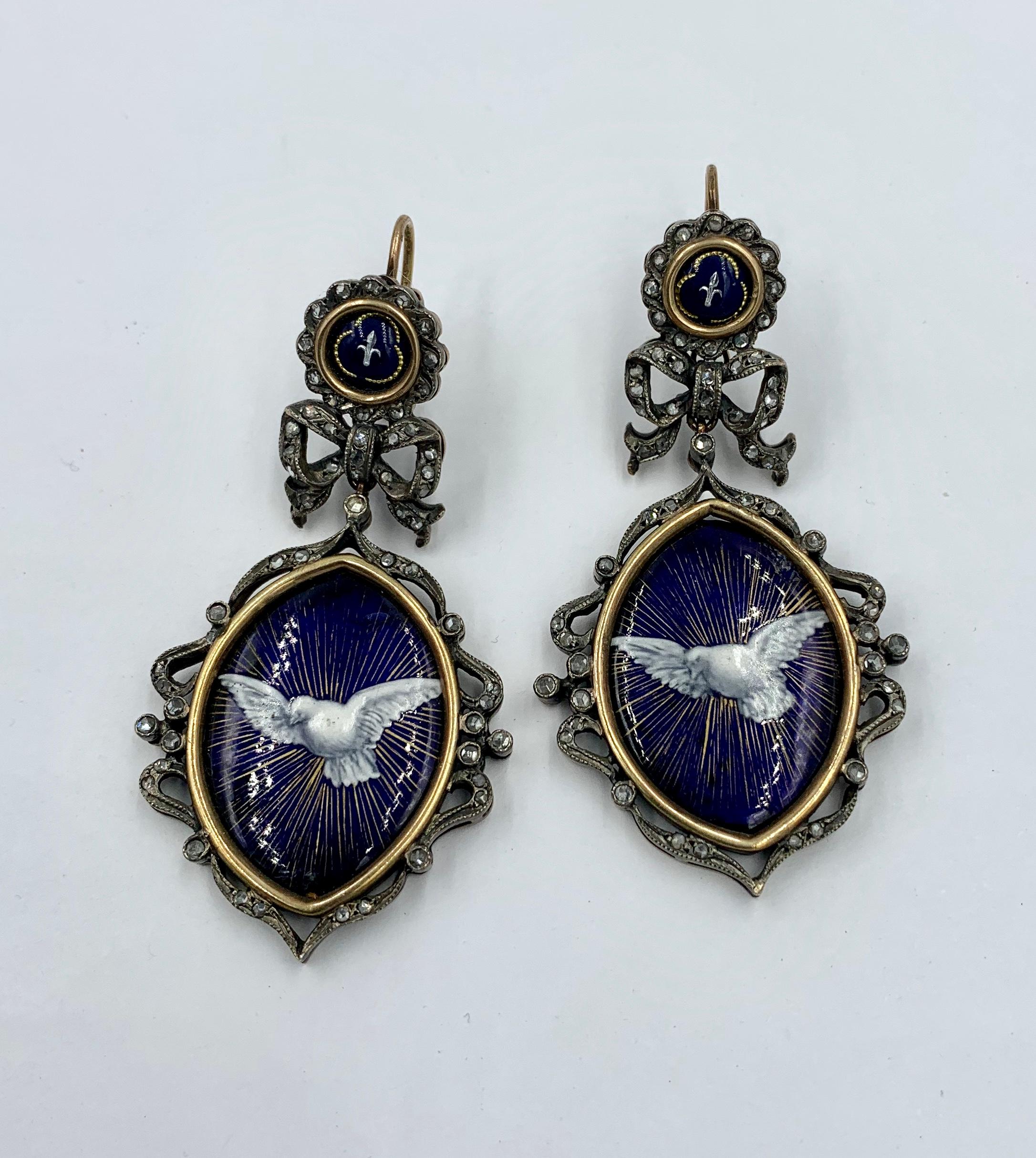 The extraordinary Enamel Rose Cut Diamond Dove Bird Earrings are Museum Quality Jewels which date to the Georgian to Victorian period.   The pendant dangle drop earrings have an image of a dove in flight against a royal blue background with the