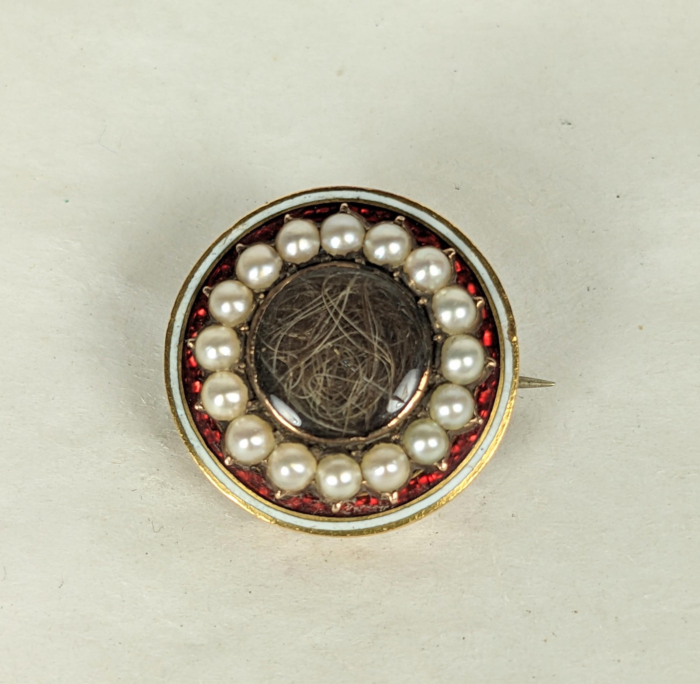 Georgian Enamel Remembrance Brooch with hair compartment under glass from the early 19th Century. Set in 10K gold with unusual ruby enamel with half seed pearls. This was originally a bracelet or necklace clasp and was transformed into a brooch
