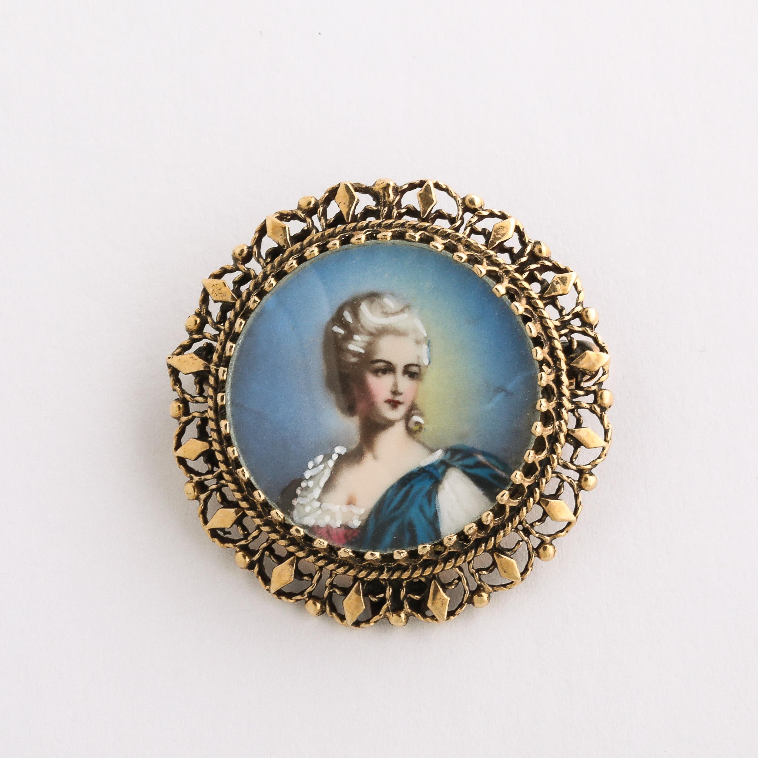 This Georgian Enameled & Hand-Painted Portrait Pin W/ 14 Karat Gold Setting is a lovely piece, classical and made with beautiful materials and detailing. This Pin features a portrait of a woman with coiffed hair and Georgian Style Dress, with