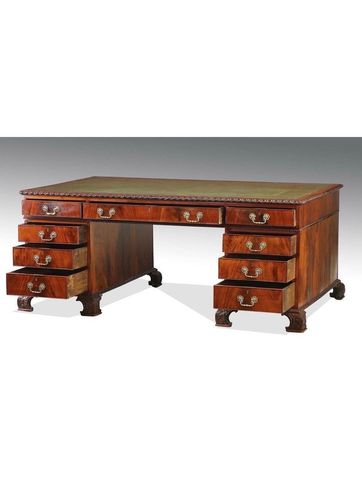 English, 19th century.

19th century English partners' desk, the top with a gadrooned edge and inset with a gilt tooled green leather writing surface, all raised on carved curving feet, in the Chinese chippendale style. Absolutely incredible desk