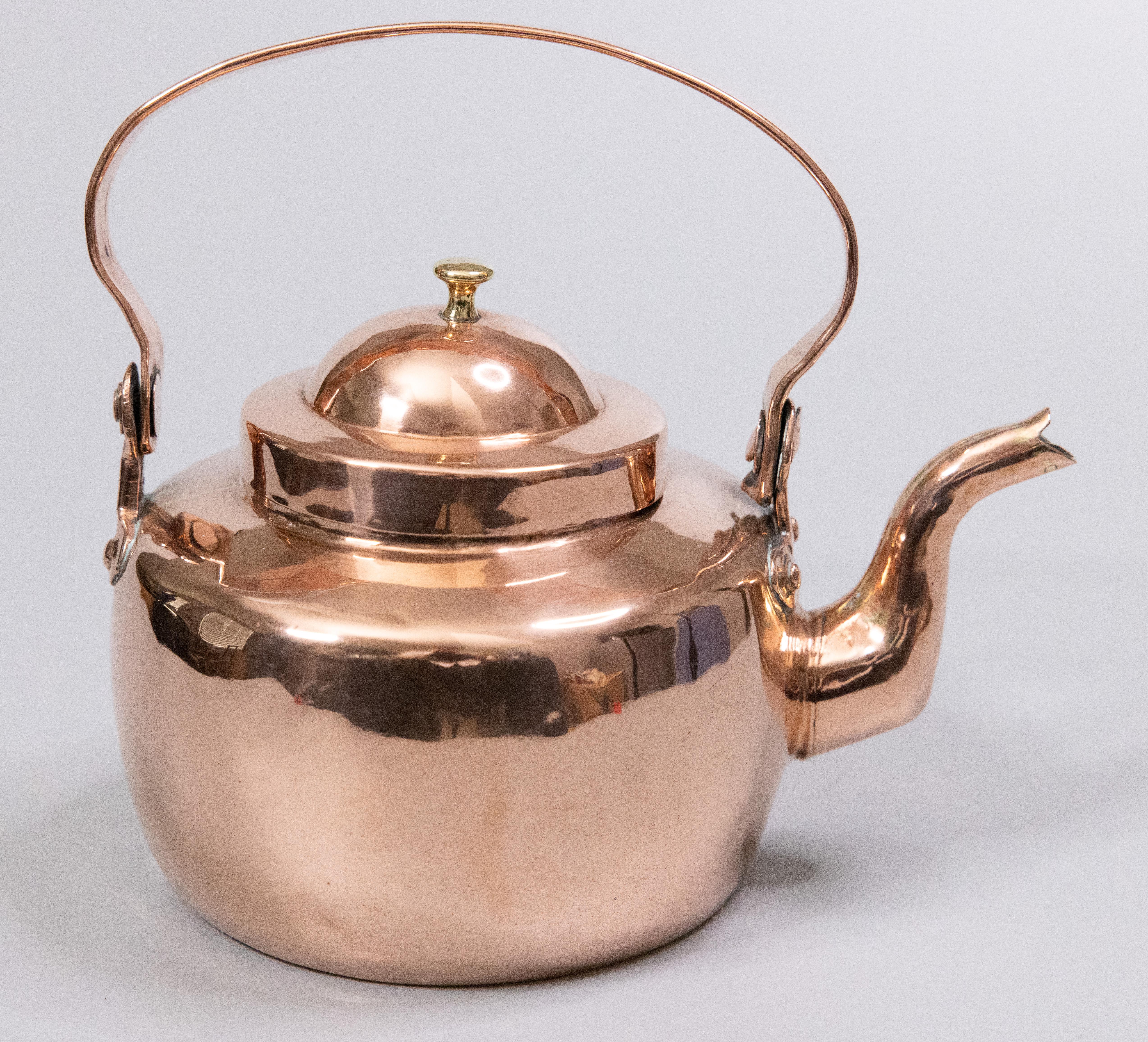 A lovely petite antique Georgian English handmade copper and brass tea kettle or teapot with a swing handle, circa 1820. This would a charming addition to your kitchen decor or to a copper collection. It is 6.25