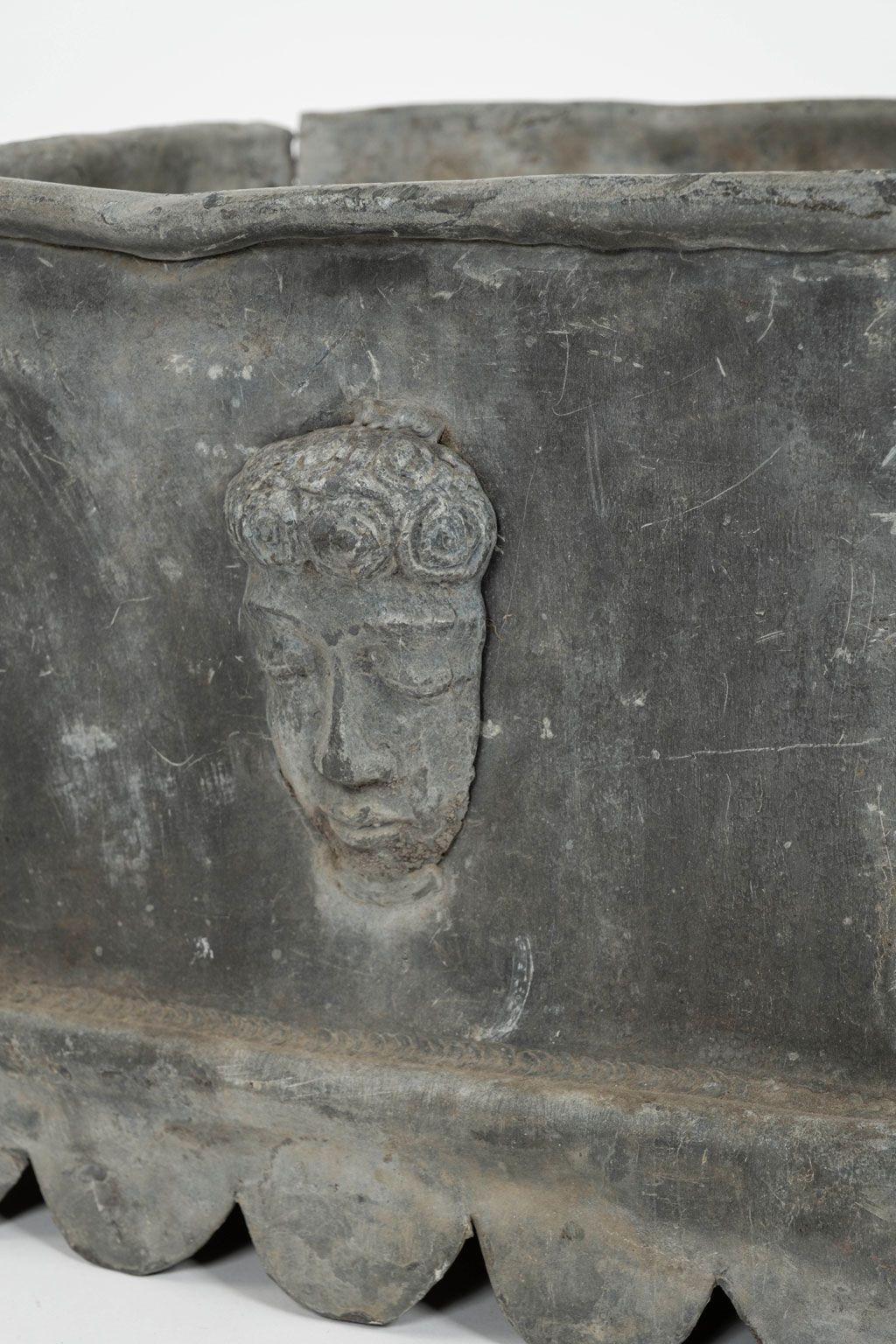 English Georgian Lead Planter in neoclassical style circa 1780-1799. Square shape with serpent drain spouts and face decoration on one side. Priced $4600.
Second round Georgian planter available (see images), and sold individually.