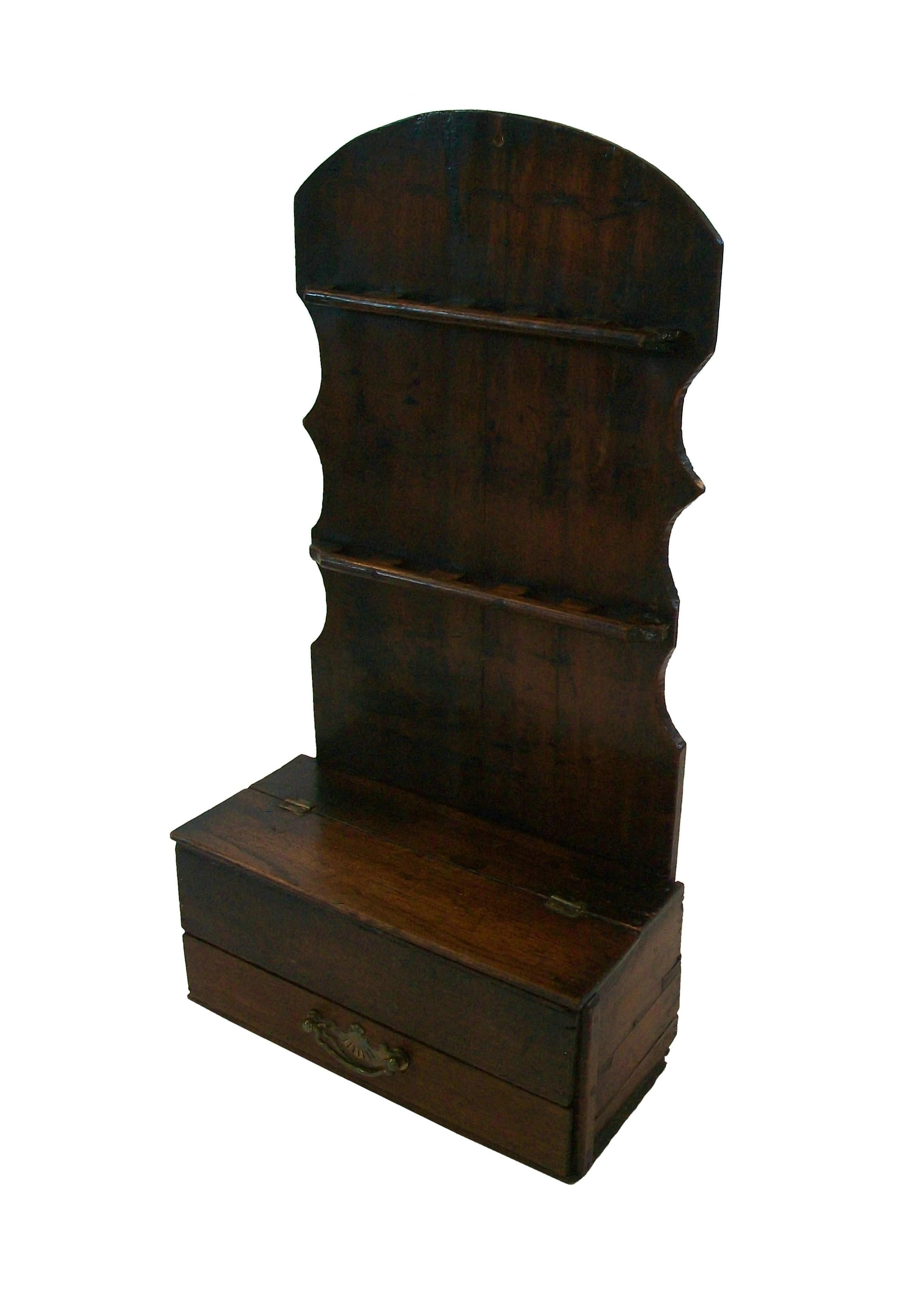 Georgian English Oak spoon rack with a dark brown stain and warm aged patina - table/counter placement or wall mounted - featuring a lower drawer with brass pull handle (replaced) and a hinged box to the top of the base - appears to be the original