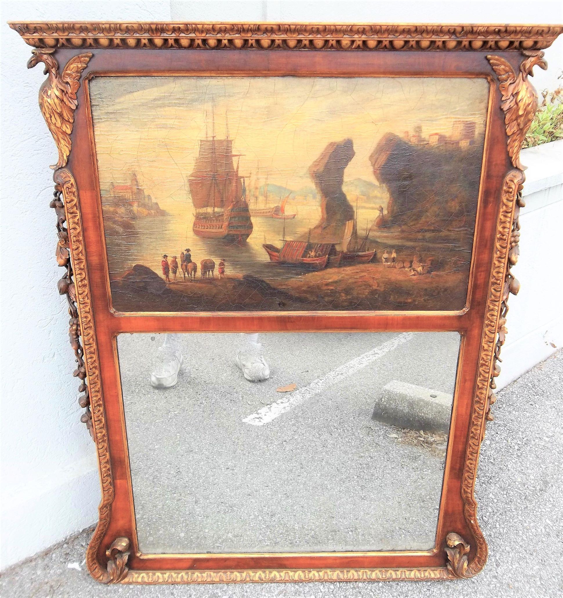 A seascape or landscape encased by walnut frame with carved giltwood decoration. The lower mirror plate showing signs of silver separation, spotting and diamond dust. Both plate and oil appear original, circa 1760. A very fine and somewhat rare