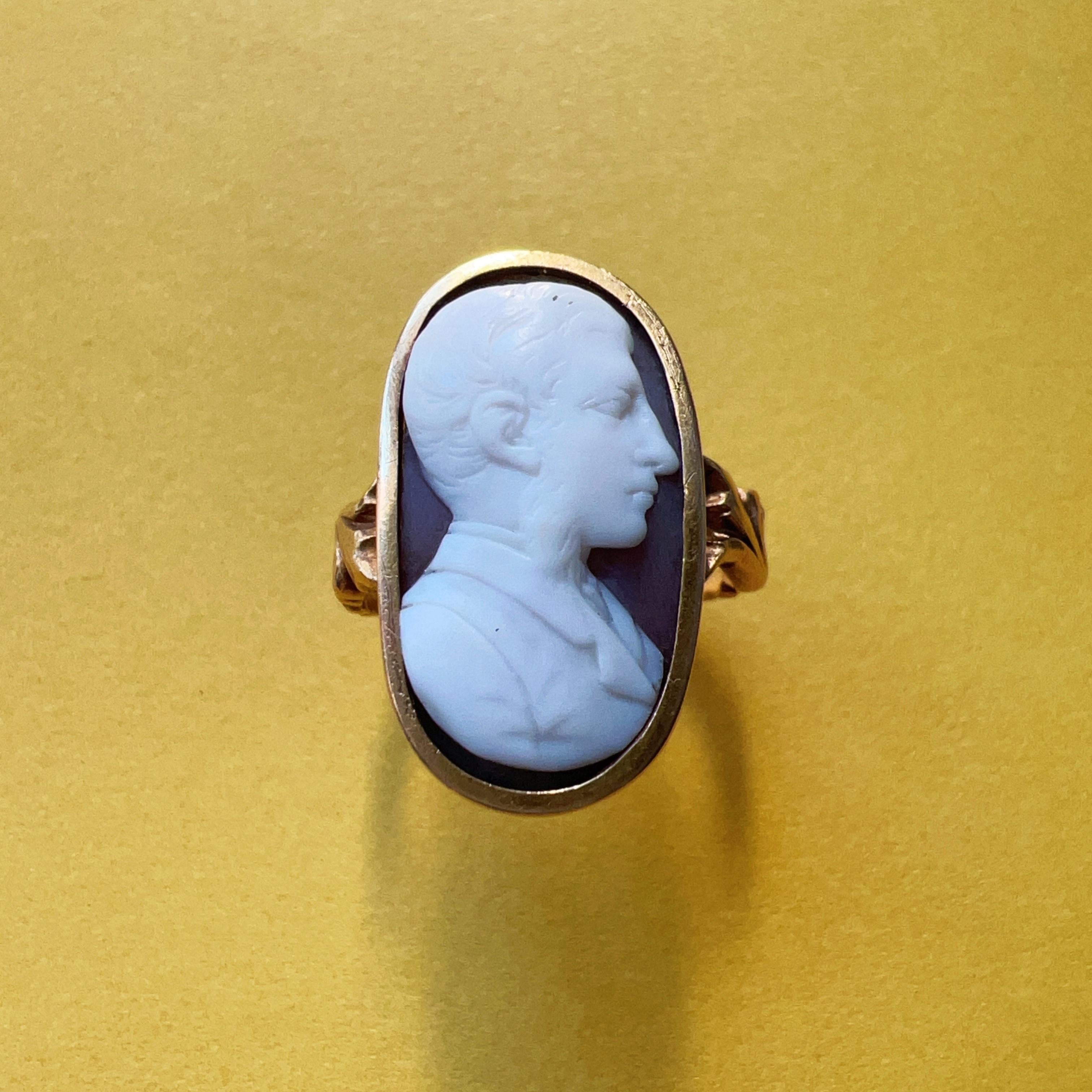 For sale a 18th Century 18K gold empire period cameo ring.

This rare ring showcases a remarkable white and brown two-colored hard stone cameo portraying the profile of a distinguished gentleman. The intricacies of his hair, beard, and clothing are