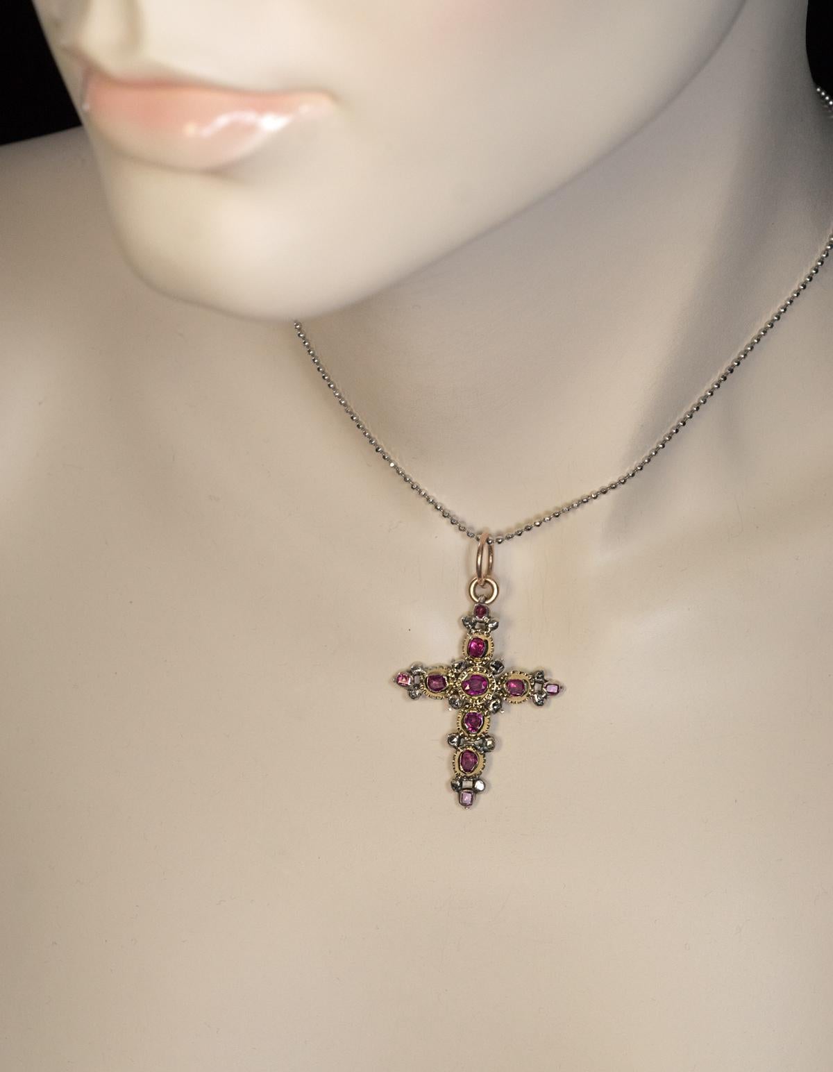 This rare 18th century gold (approximately 16.5K) and silver cross is embellished with rubies and rose cut diamonds set in rub-over settings. The center ruby is of an oval cut, other 9 rubies are of a table cut.

The rubies of the cross symbolize