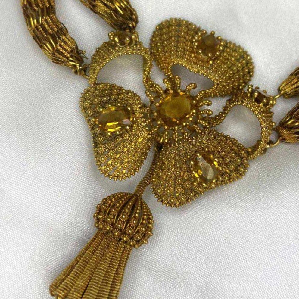 A captivating treasure from the Edwardian era, this exquisite necklace is a testament to the artistry and refinement of early 19th-century jewelry design. Handcrafted circa 1815 in rich 18k yellow gold, it features an elaborate open lace-work