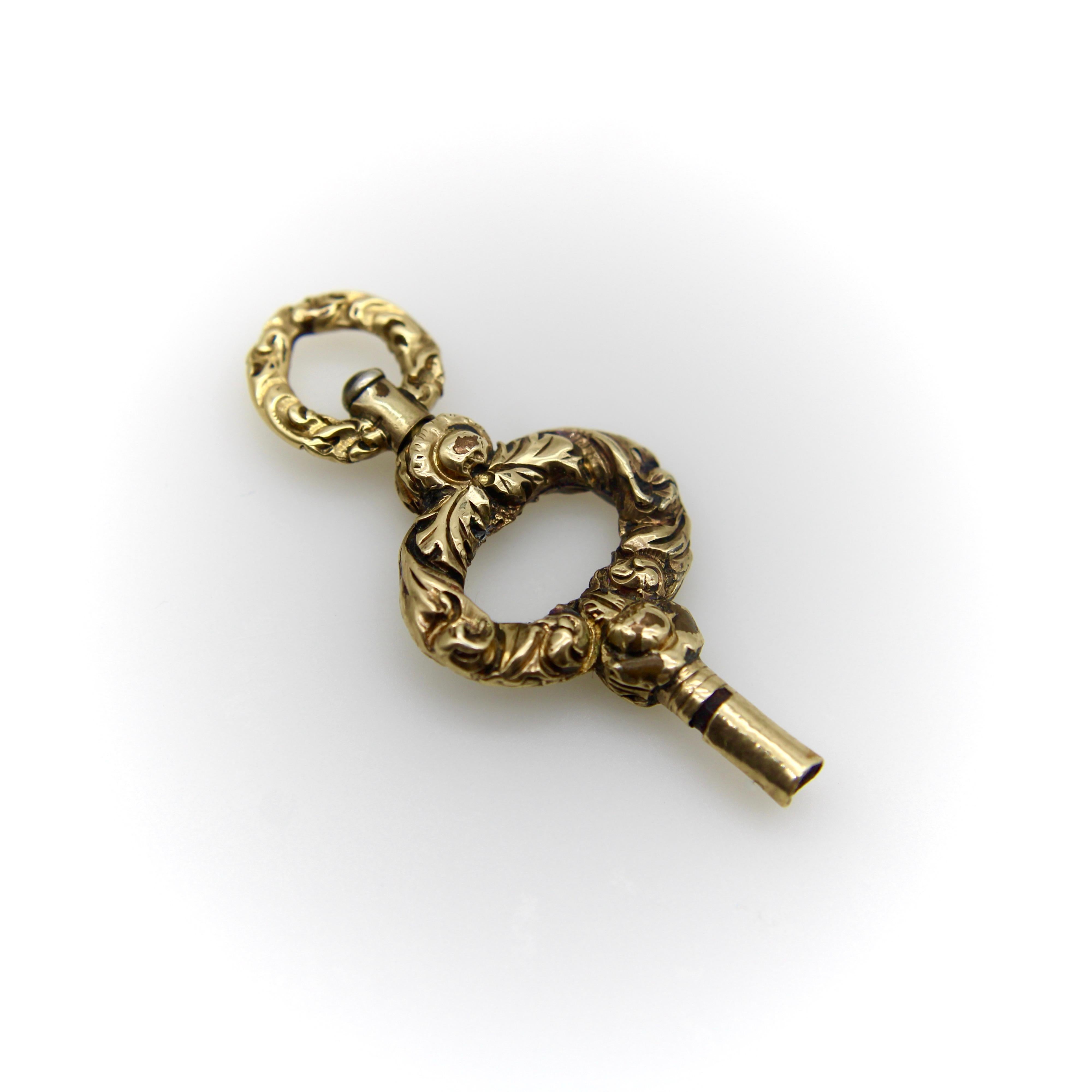 This elaborate gold case Georgian watch key fob is ready to hang on a chain of your choice! The key has nice proportions, is short and squat in shape, with a border of flowing foliate that wraps around the key on both sides. The foliate is