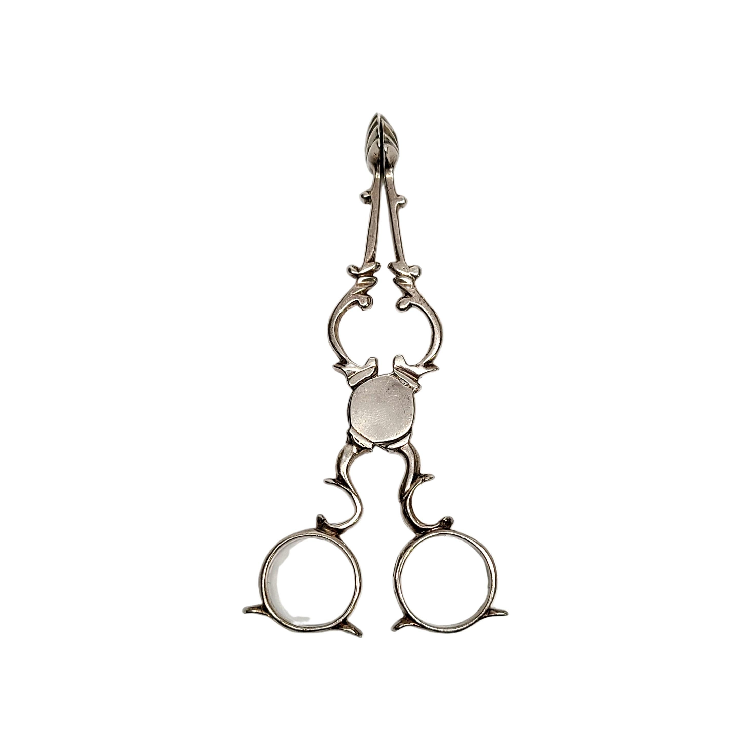 Georgian Era sterling silver Tea Tongs or Sugar Nips.

The scissor shaped Tea Tongs/Sugar Nips were used from circa 1720-1770. 18th Century nips were typically marked on the finger rings with the maker's mark and the lion passant, as these are.