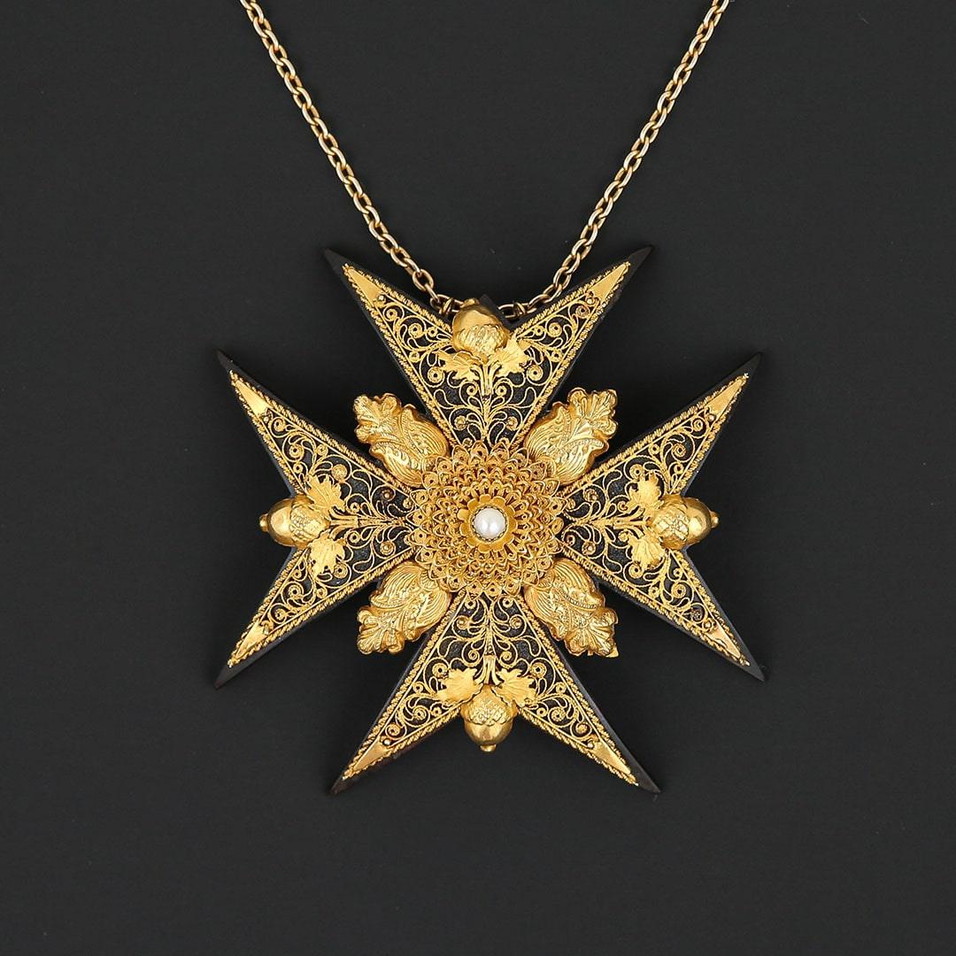 A magnificent and rare large Georgian gold, piqué and seed pearl Maltese cross pendant with intricate canetille, filigree and acorn motifs. The piece is of museum quality having been exceptionally well looked after. A simialr piece can be found in