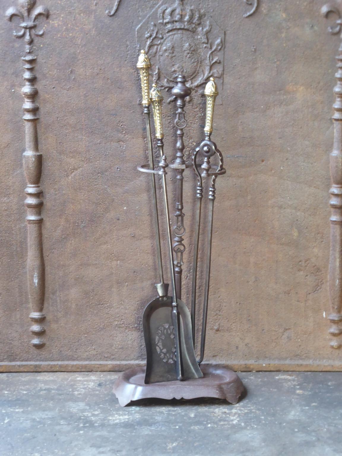 Beautiful set of three Georgian fireplace tools made of forged iron with polished brass handles and a wrought iron stand. Made in England, 18th-19th century. The fire tool set is in a good condition and is fully functional.








   