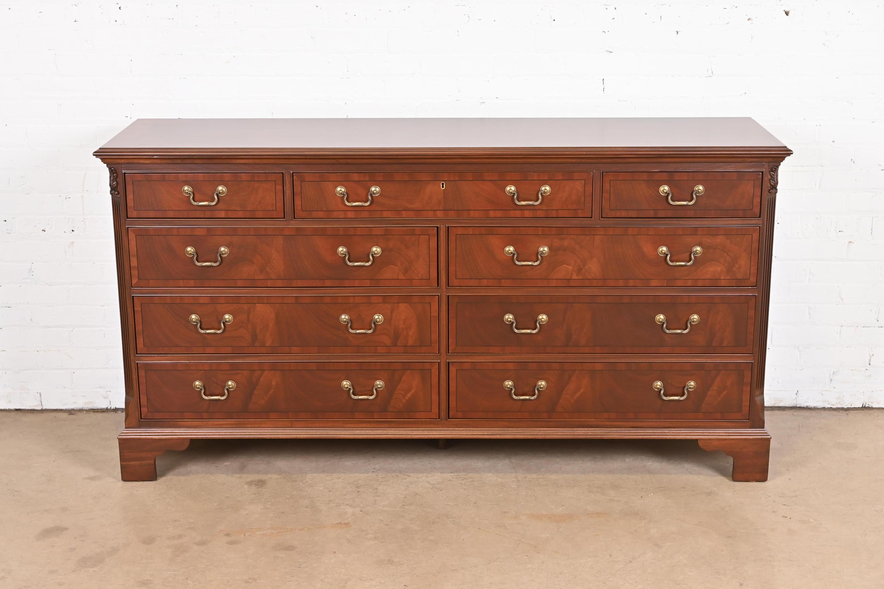 A gorgeous Georgian or Chippendale style nine-drawer dresser or credenza

USA, Circa 1990s

Beautiful banded flame mahogany, with original brass hardware.

Measures: 70