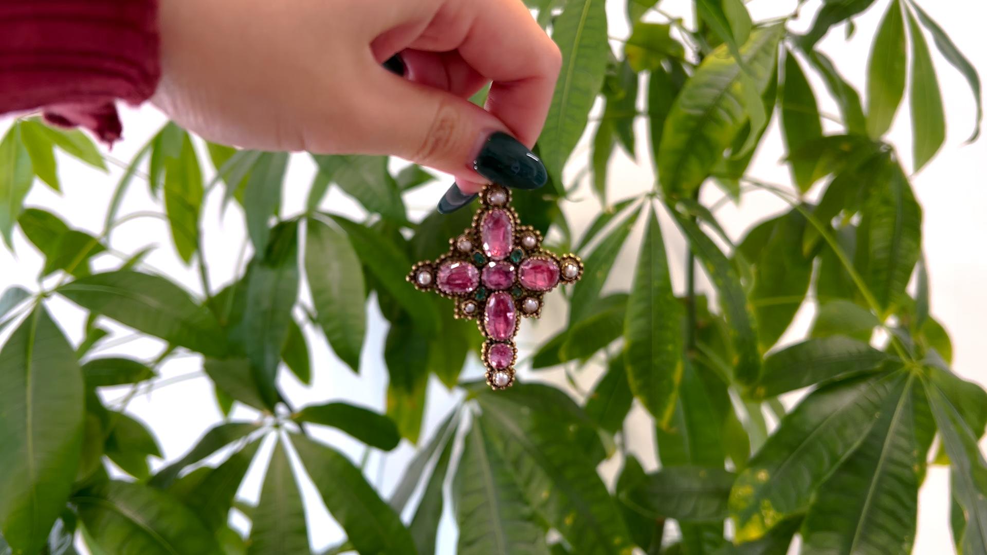 One Georgian Foiled Back Pink Topaz, Emerald, and Pearl 14k Yellow Gold Cross Pendant. Featuring six foiled back pink topaz weighing approximately 10.00 carats. Accented by four octagonal step cut emeralds with a total weight of approximately 0.20