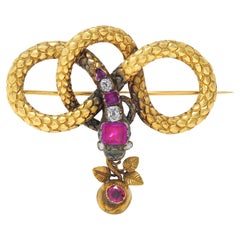 Broche georgiano francés de oro amarillo de 18 quilates con diamantes y rubíes Antiguo nudo de serpiente