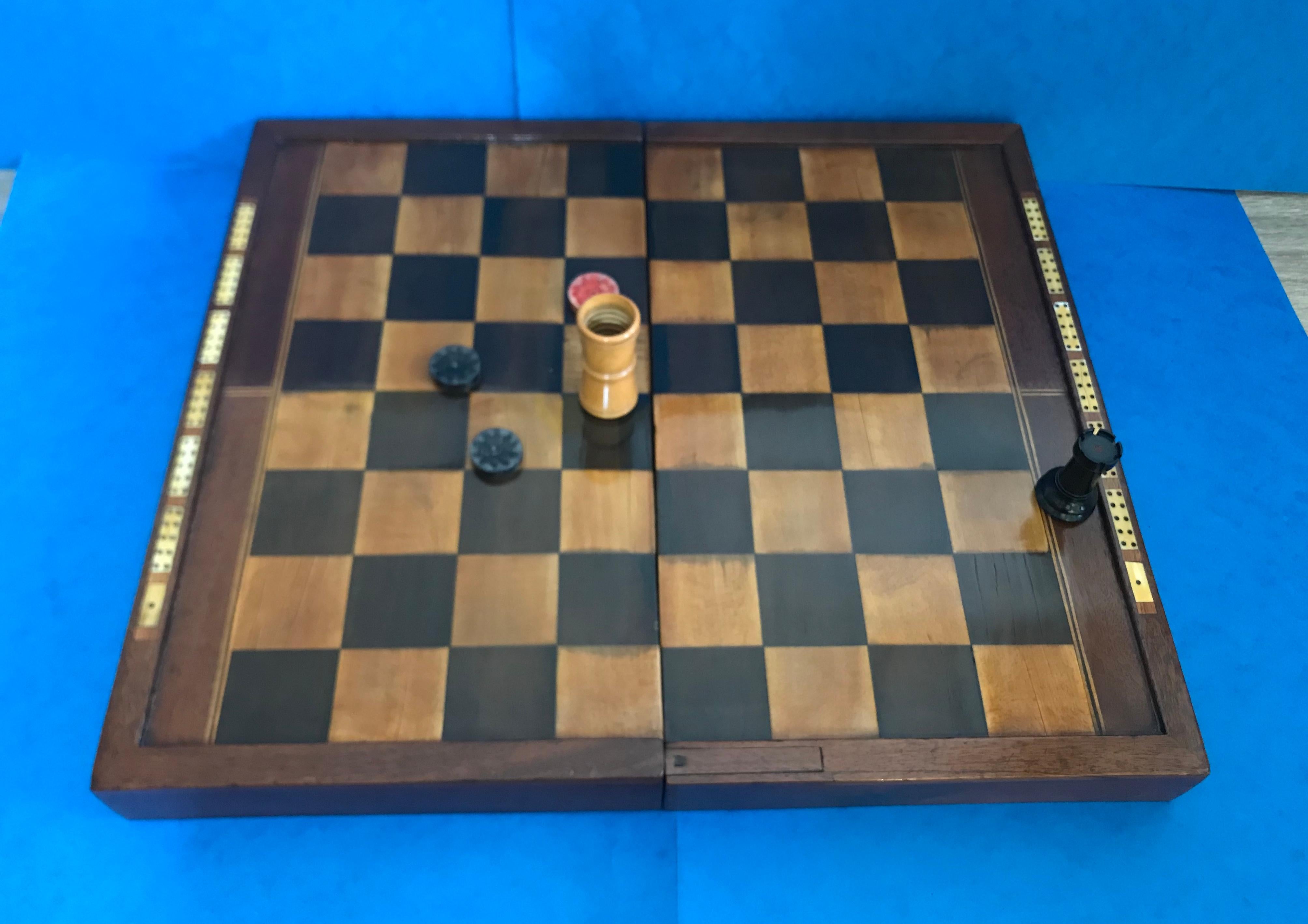 Georgian games box, complete with a ‘Stalton’ chess set and a soapstone backgammon set.
An exquisite solid mahogany and fruitwood inlaid games box that dates back to 1820. The squares of the board are inlaid with ebonised fruitwood and apple