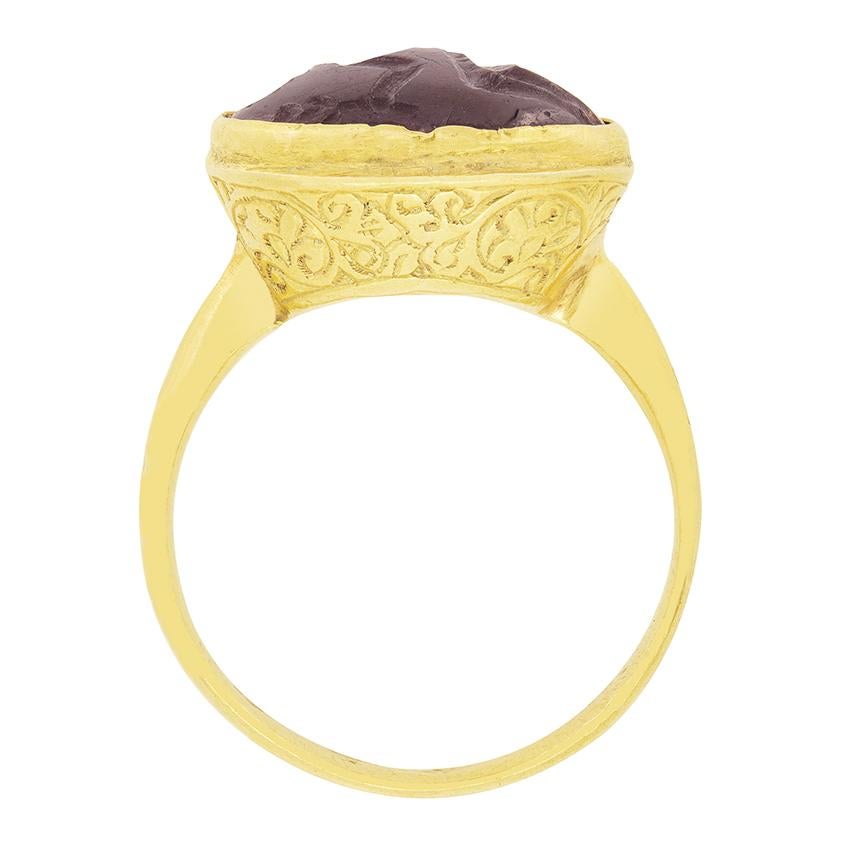 A true piece of history, this extraordinary ring dates back to the early 1800s in the Georgian period. Sat atop the ring a seal of garnet features the imprint of a lady. The imprint is engraved in such a way that, when pressed into melted wax, the