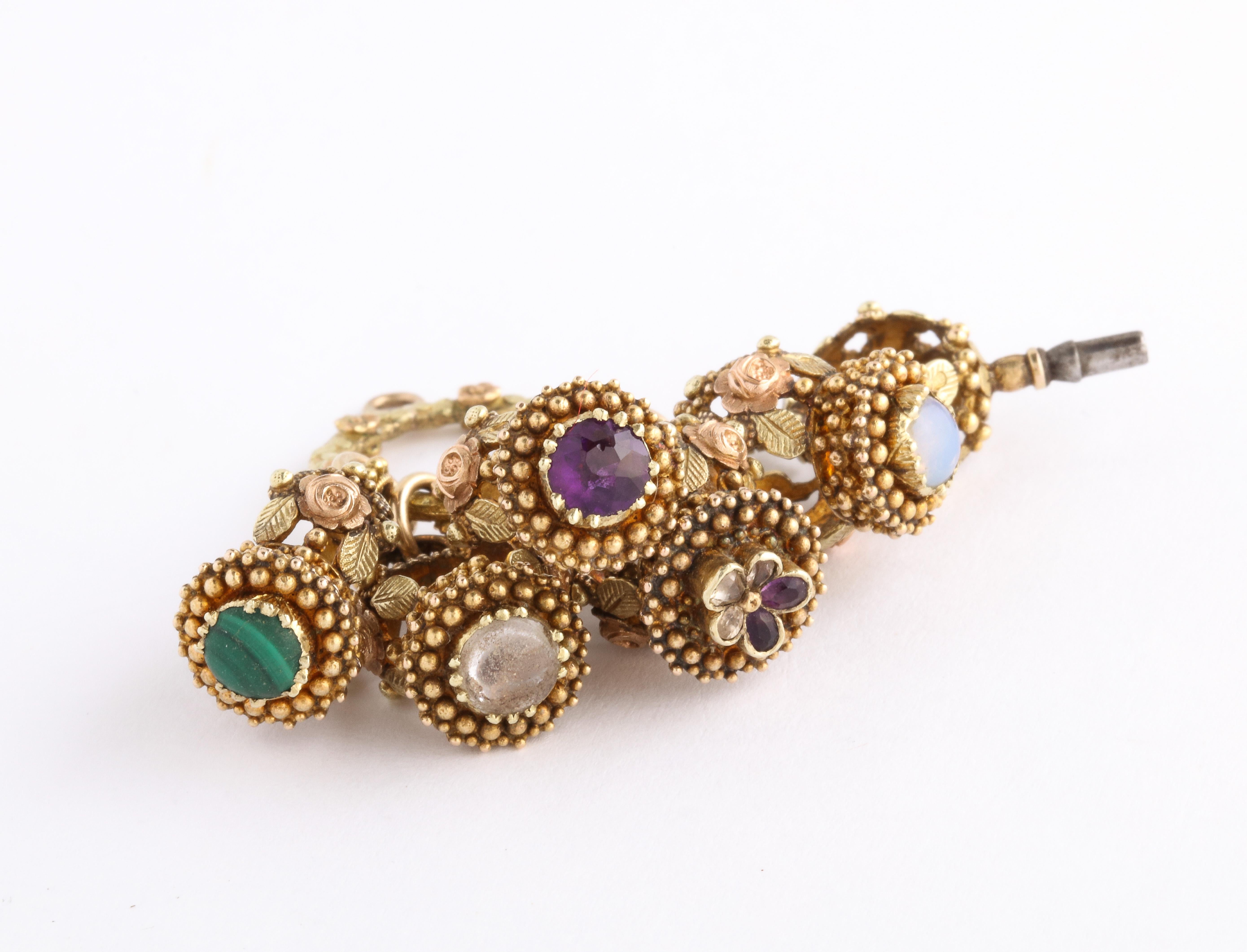 From France c. 1810, a magnificent of 18 Kt gold Georgian Fobs completely encrusted with granulation, roses and leaves come split ring attached. This is a rare fob display for advanced jewelry collectors. The Fobs house amethyst, topaz, opal, rock