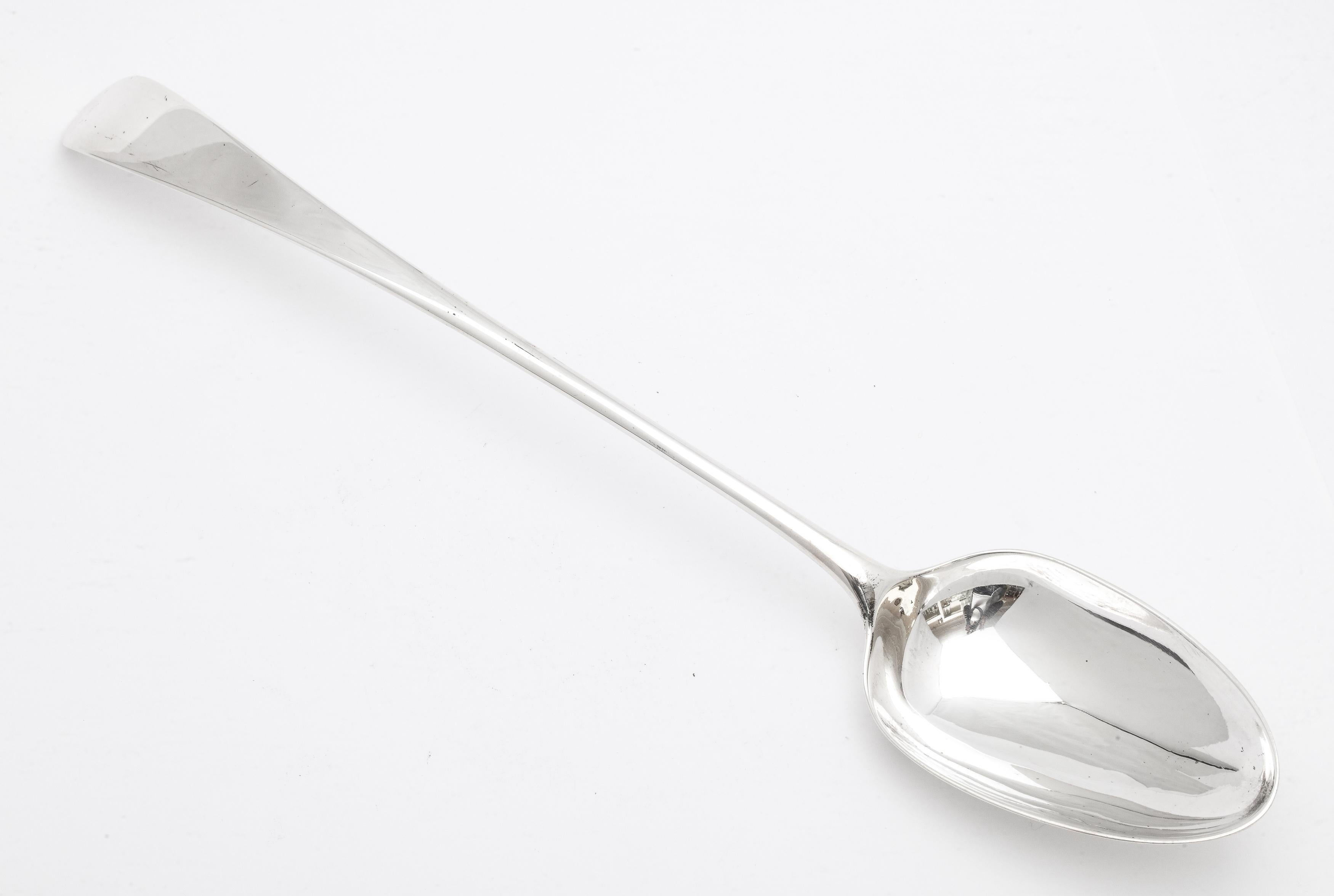 Georgian (George II), sterling silver stuffing spoon, London, year-hallmarked for 1738, Thomas Whipham - maker. Measures 11 inches long x 2 inches deep (at deepest point) x 1 1/2 inches high when lying flat. Weighs 2.905 Troy ounces. Dark spots on