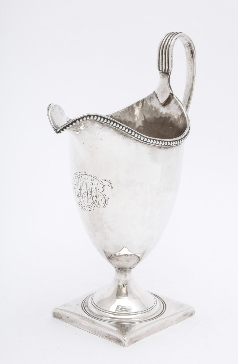 Georgian (George III), sterling silver, helmet-form cream jug/pitcher on square, pedestal base, London, year-hallmarked for 1795, Peter and Anne Bateman - makers. Measures 5 3/4 inches high (to top of handle) x 4 inches wide (from outer edge of
