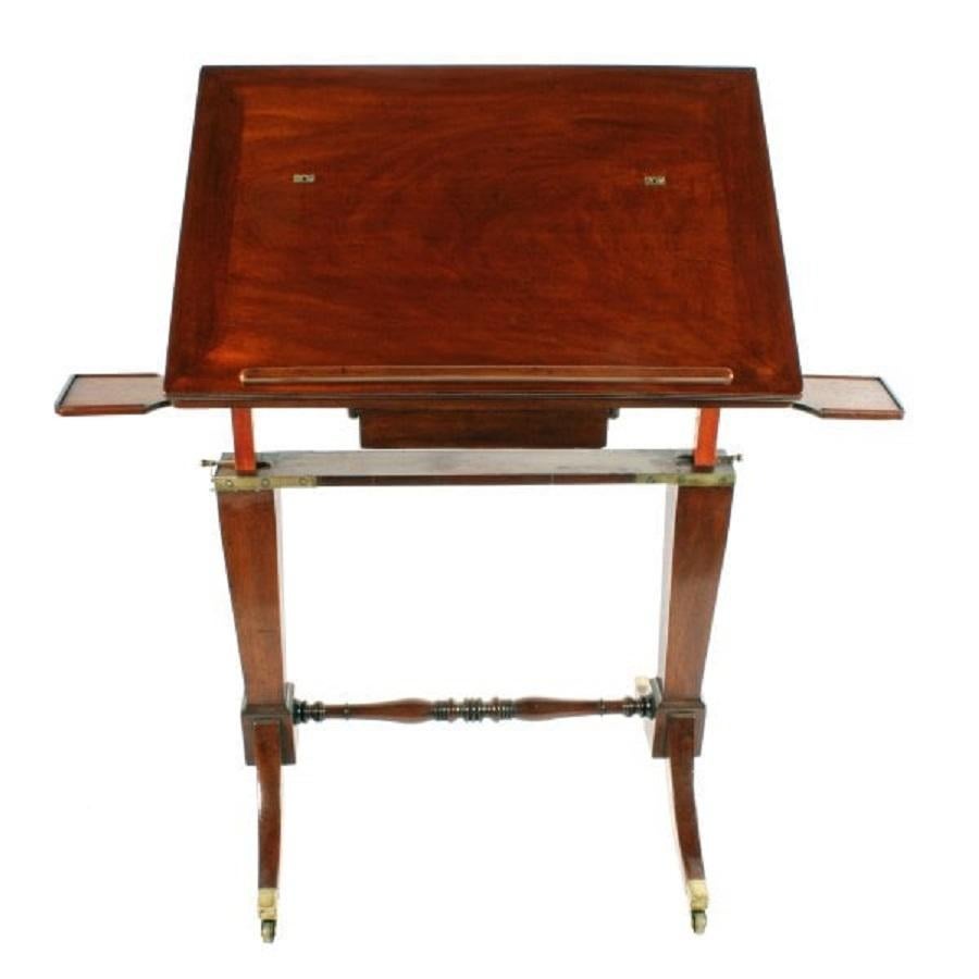 An early 19th century Georgian mahogany architect's table stamped 'Gillows'.

The table has a rise and fall mechanism to adjust the height and two squared supports that are tapered and have brass strapping at the top.

The base has four sabre