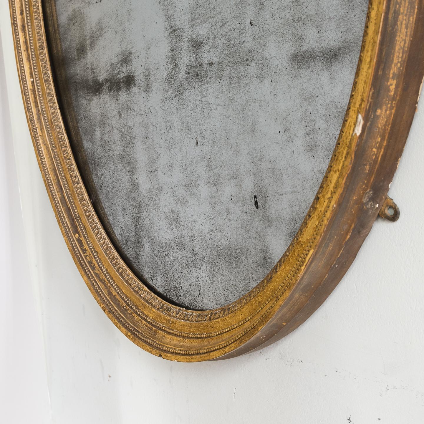 A good Georgian gilt composition oval mirror, circa 1800, with original mercurial plate glass.

 