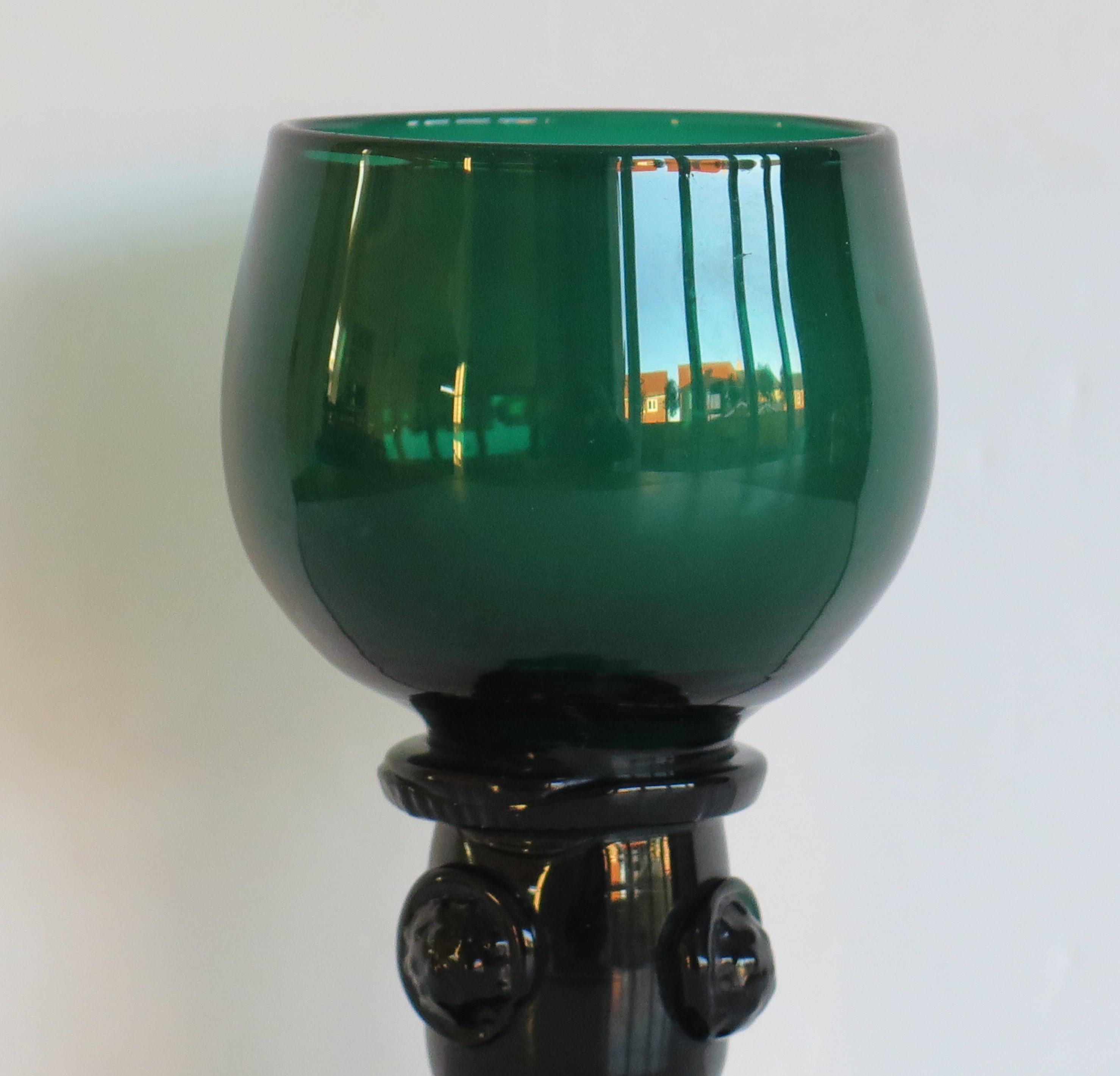 This is an excellent example of an early 19th century, English, hand blown, Bristol green wine drinking glass or ROAMER which we date to the George 111rd Regency period, circa 1815.

These glass ROAMERS are fairly rare. The glass has a cup bowl with