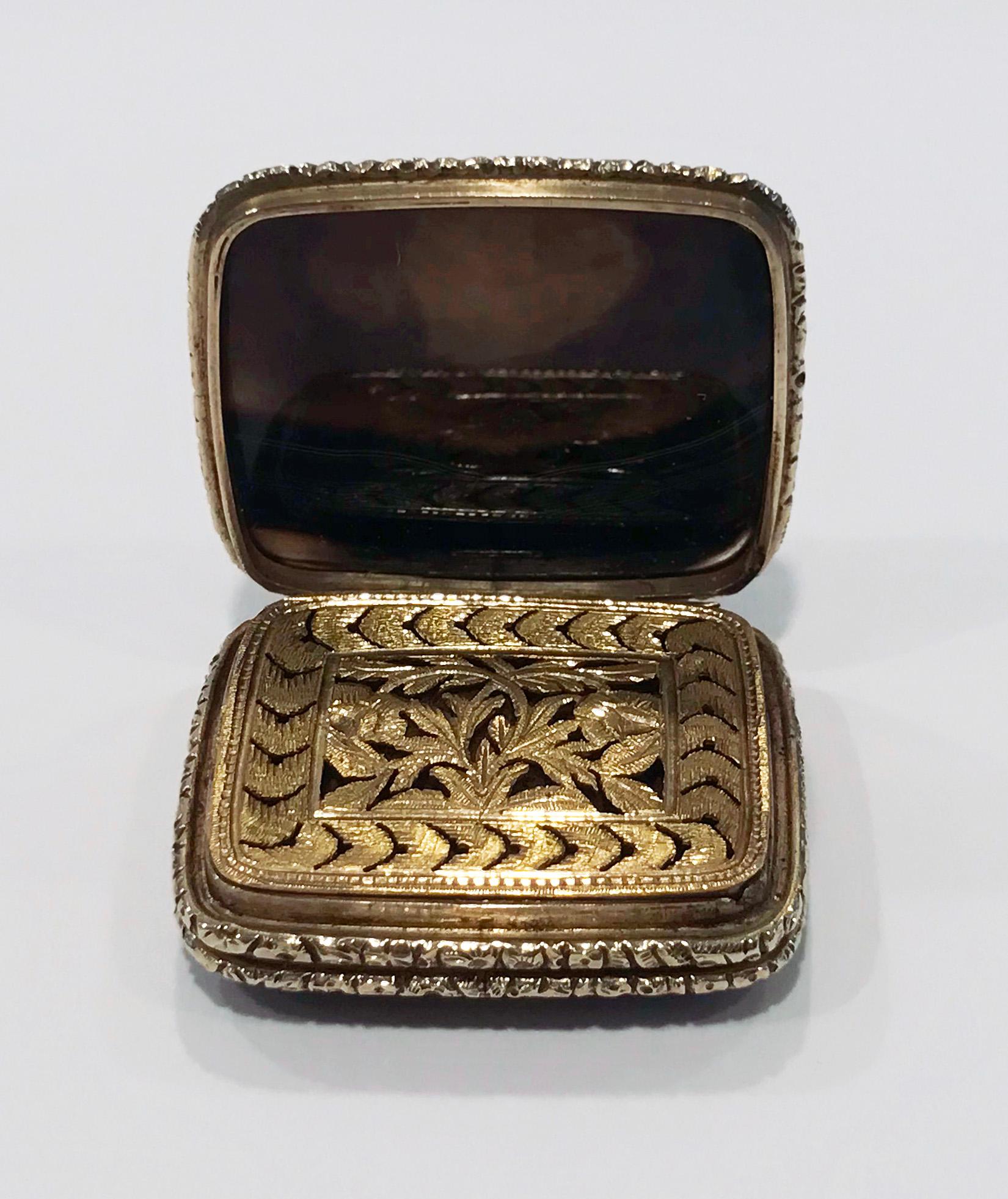 Georgian Gold and Agate Vinaigrette, C.1820. The rectangular shape vinaigrette with hinged cover and underside set with agates, the interior with beautiful pierced foliate engraved grille, the surround cannetille rosette foliate gold. Gold tests as