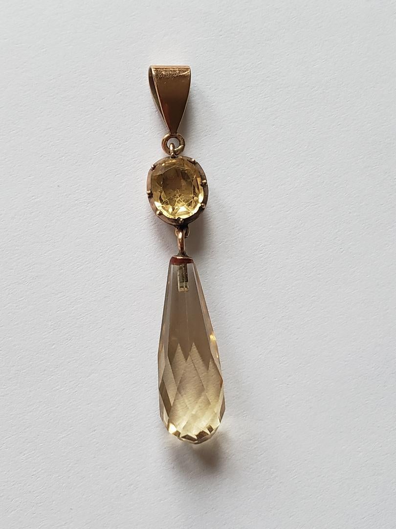 A Lovely Georgian c.1800 9 Carat Gold and Citrine drop pendant. Top stone in foiled closed back setting suspending briolette cut Citrine.

Total drop including bale 43mm.
Unmarked, tested 9 Carat Gold.
Weight 2.6gr.

The pendant in very good