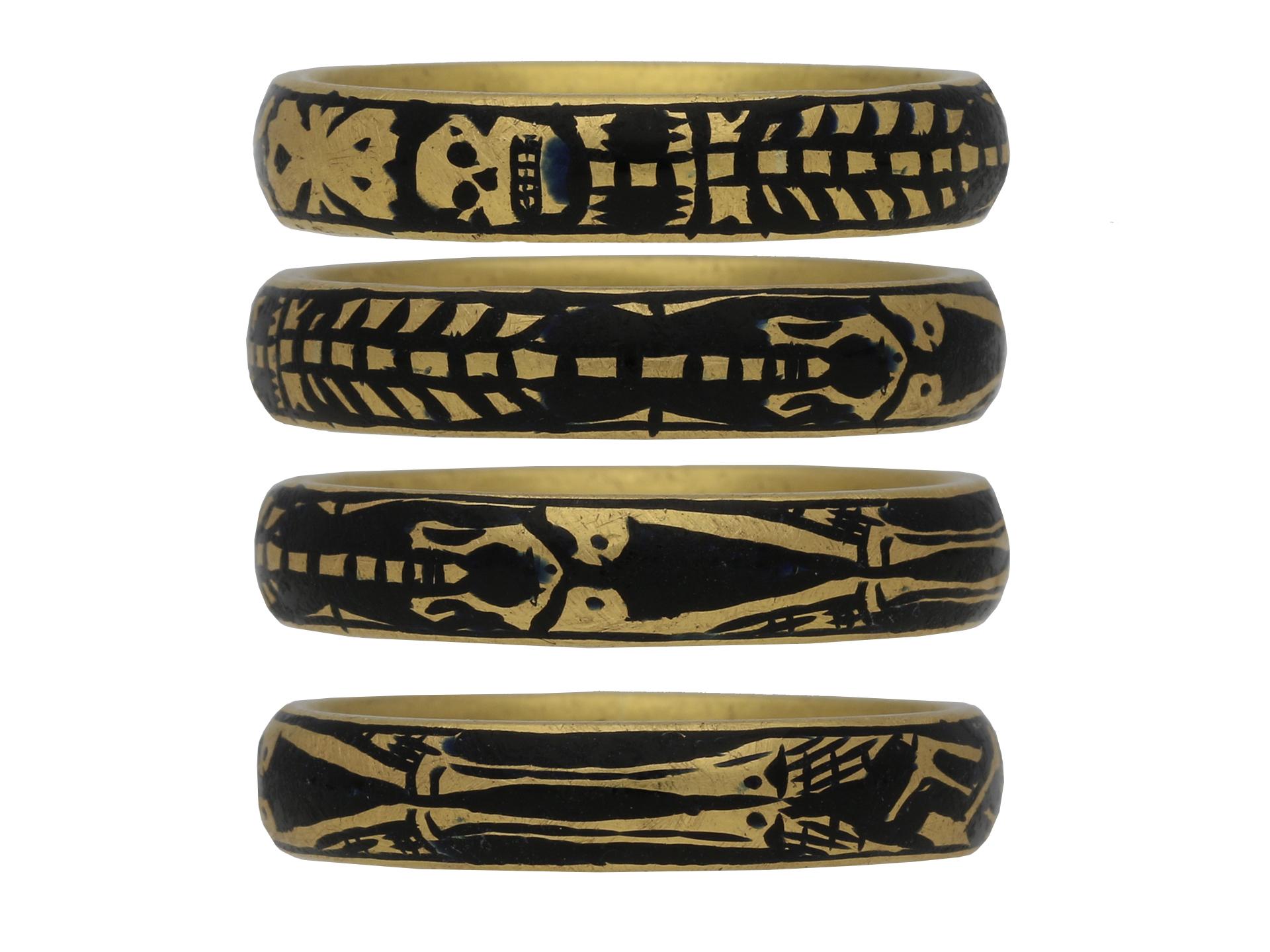 Georgian gold and enamel memorial skeleton ring. A solid D-shape gold band featuring an elongated skeleton with stylised skull and cross bones motif on a black enamel background, engraved on the inside in italic script and infilled in black enamel