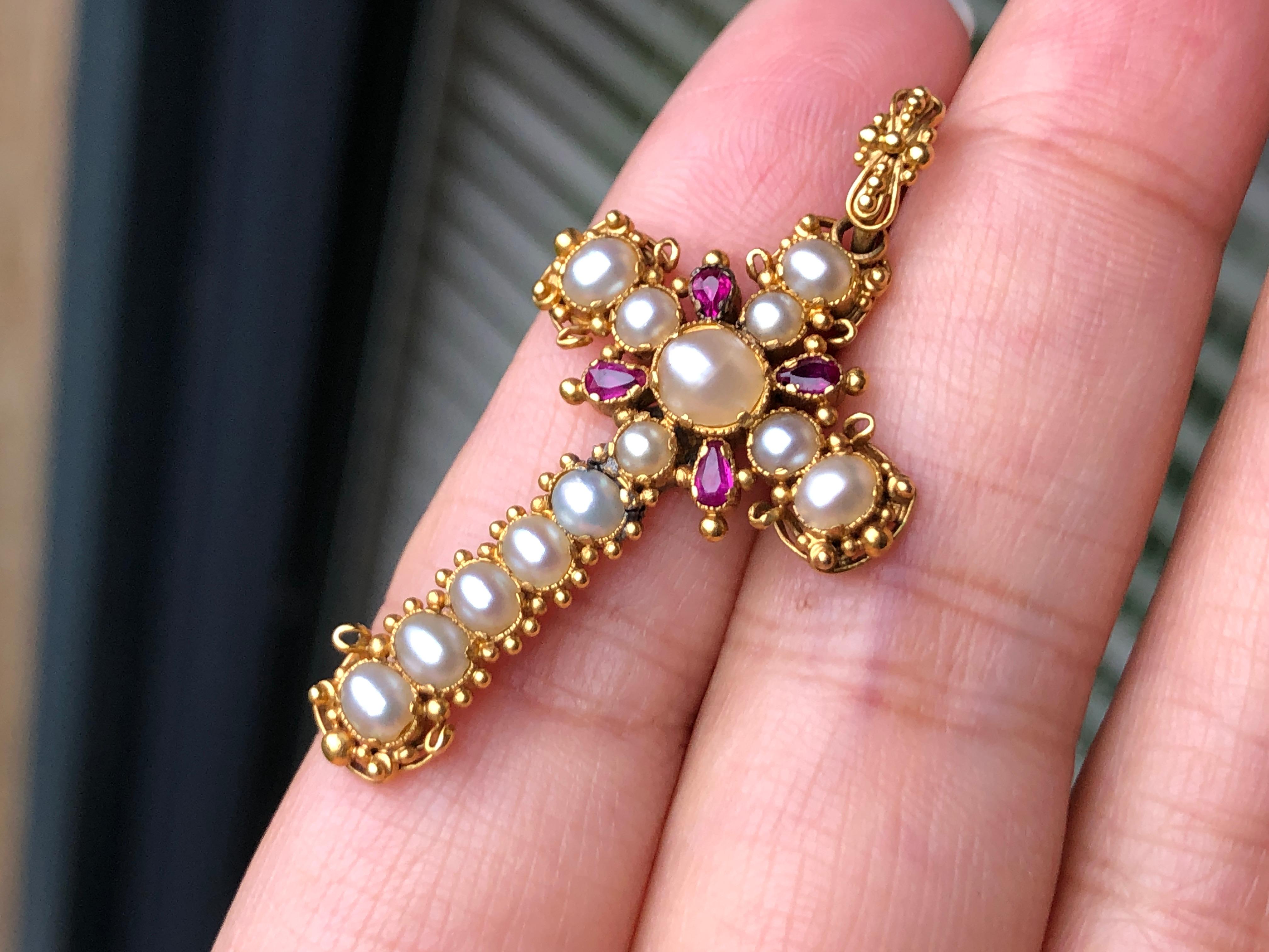A superb Georgian Italian gold ruby and seed pearl cross pendant, set with graduated creamy natural pearls in beaded and four pears cut rubies. It would be suitable as a Confirmation present.

DIMENSION
4.2cm x 2.3cm

WEIGHT
4.2g

MARKS
Unmarked,