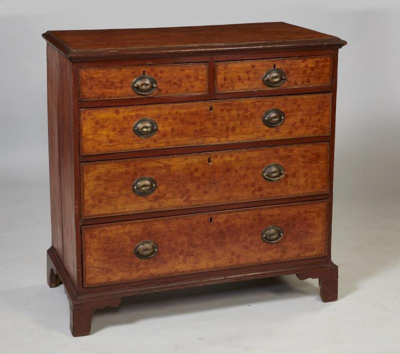 Rare George III period grain painted chest of drawers, the top with molded edge over four graduated drawers and standing on bracket feet, the whole painted to imitate satinwood with a rosewood banding - a rare survivor of this kind of decoration and