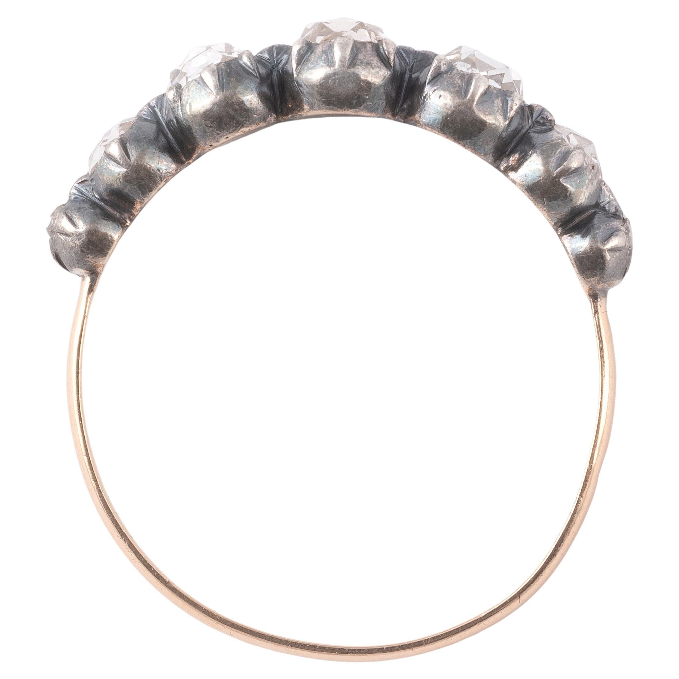 Antique ring (18K) gold and silver, set with rose-cut diamonds.
Weight: 2.6gr.
Size : 10

Georgian half hoop ring, set with seven rose cut diamonds weighing roughly 0.9 ctw, in cut-down collet settings of silver-topped gold, which taper into a