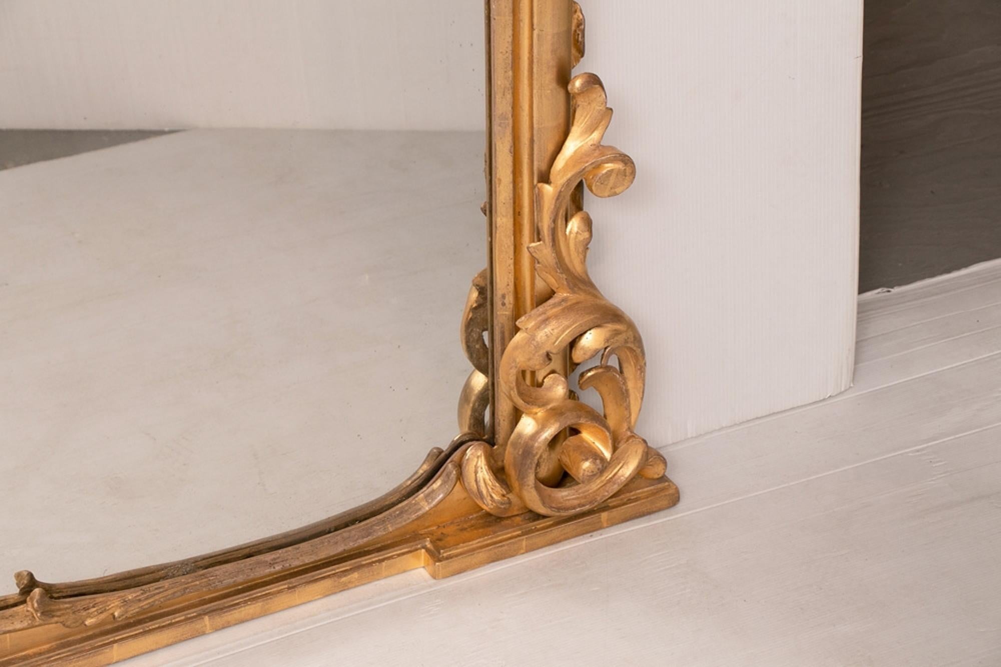 Large antique giltwood overmantle mirror circa 1820-1830. Sizes 153 cm high, 143cm wide at top, 132cm wide at base. This stunning example retains it's original watergilding in the most wonderful state of preservation. Original mercury mirror plate