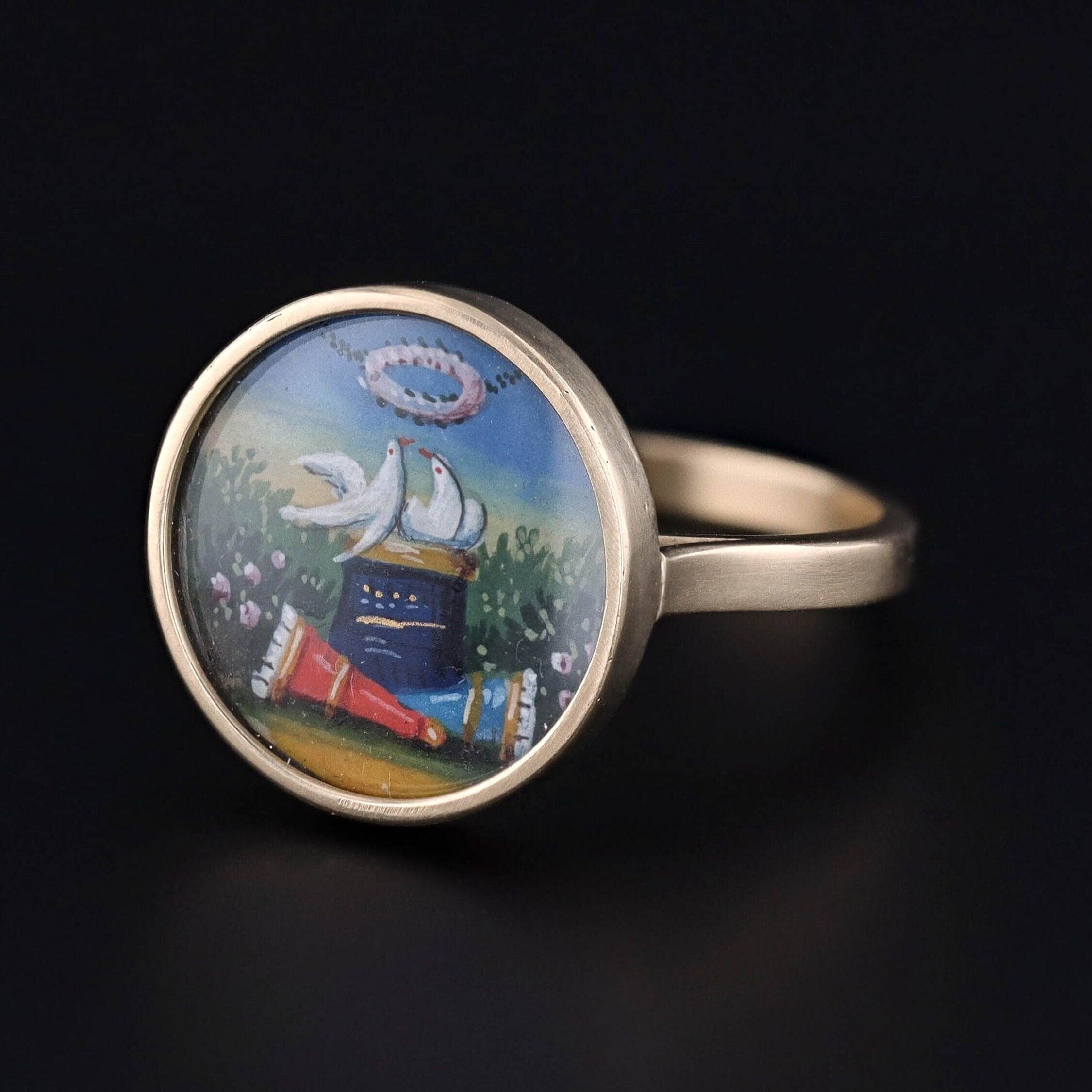 A spectacular love token ring created from a damaged Georgian pendant (circa 1790). Our jeweler transformed the piece by carefully removing the miniature and mounting it in 14k gold with a custom cut glass cover.

The ring is rich with amatory