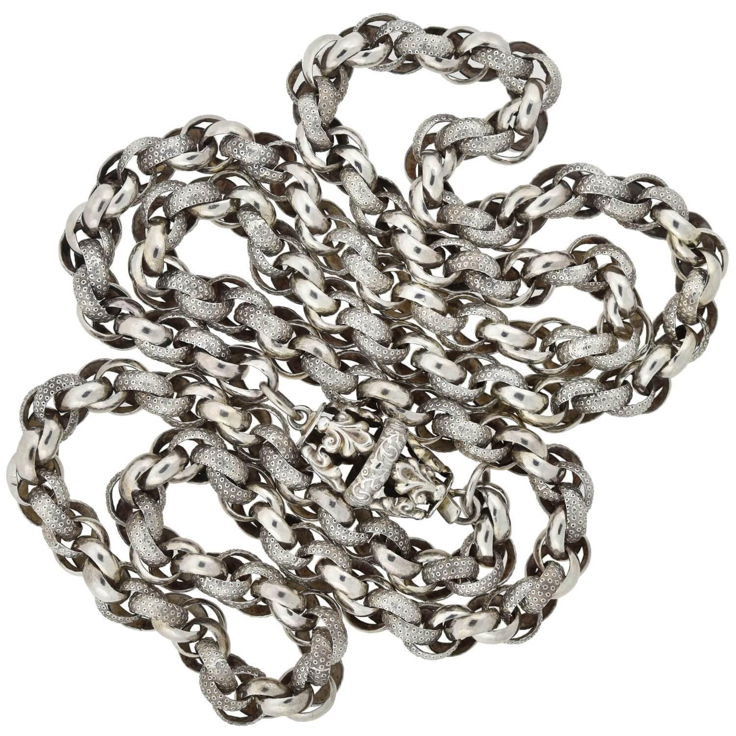 A stunning textured link chain from the Georgian (ca1830s) era! This beautiful handmade piece is crafted in sterling silver and comprised of interlocking round links, which together form a gorgeous twisted rope design. Half of the links feature a