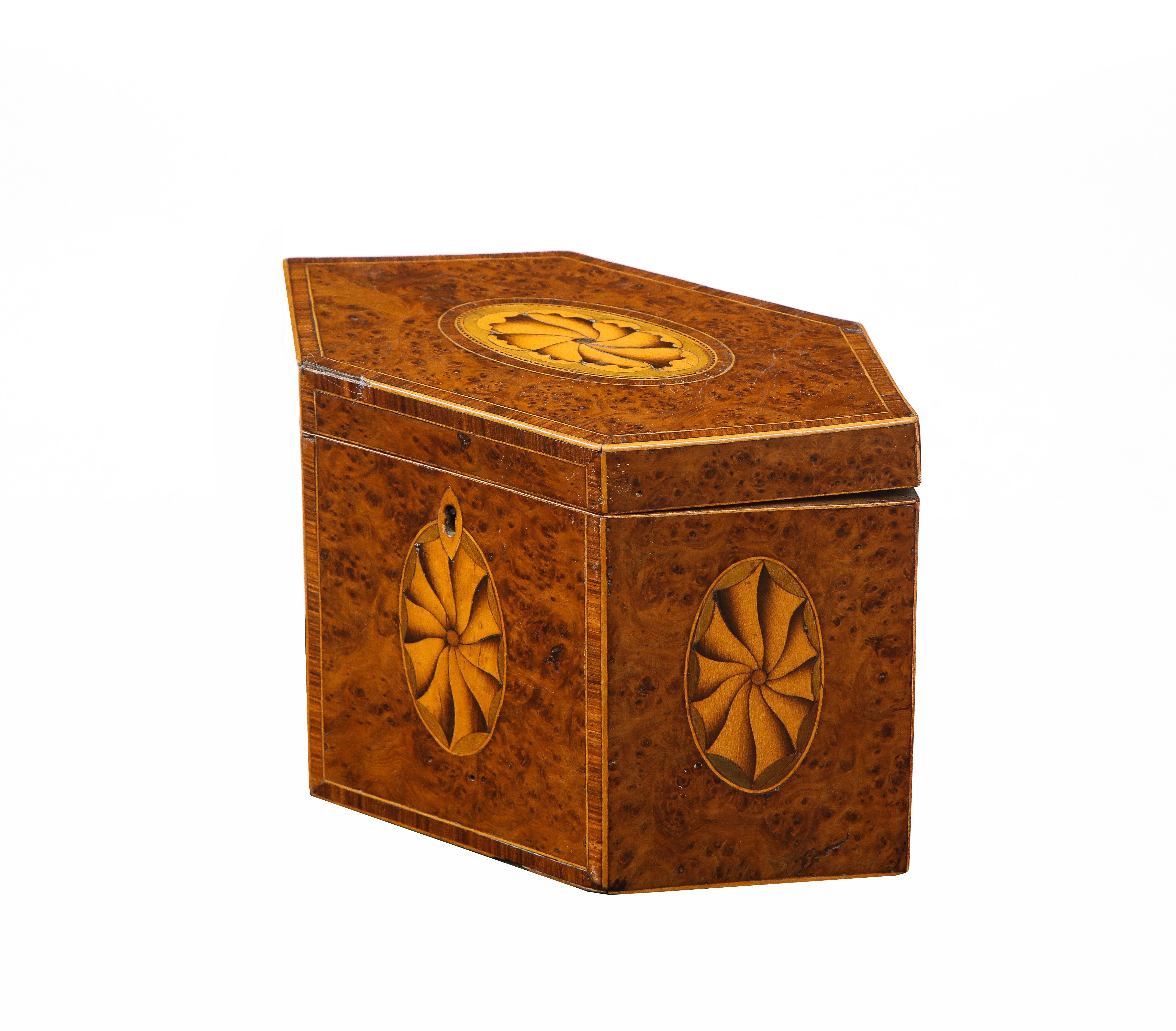 Very fine George III burr yew wood octagonal tea caddy with oval fan inlay in sand shaded holly and fustic and with kingwood banding and holly string inlay and possessing a nice, rich color.
 