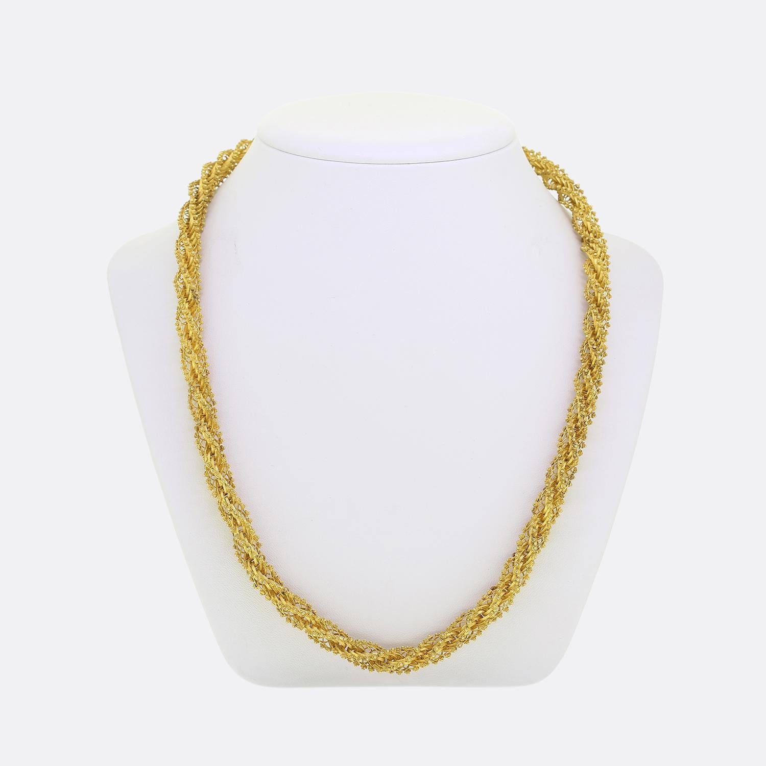 Here we have an exquisite chain necklace taken from the Georgian period. This remarkable antique piece features an intricate twisted design crafted from a rich high-carat gold. The necklace is adorned with a clasp embellished with vibrant blue
