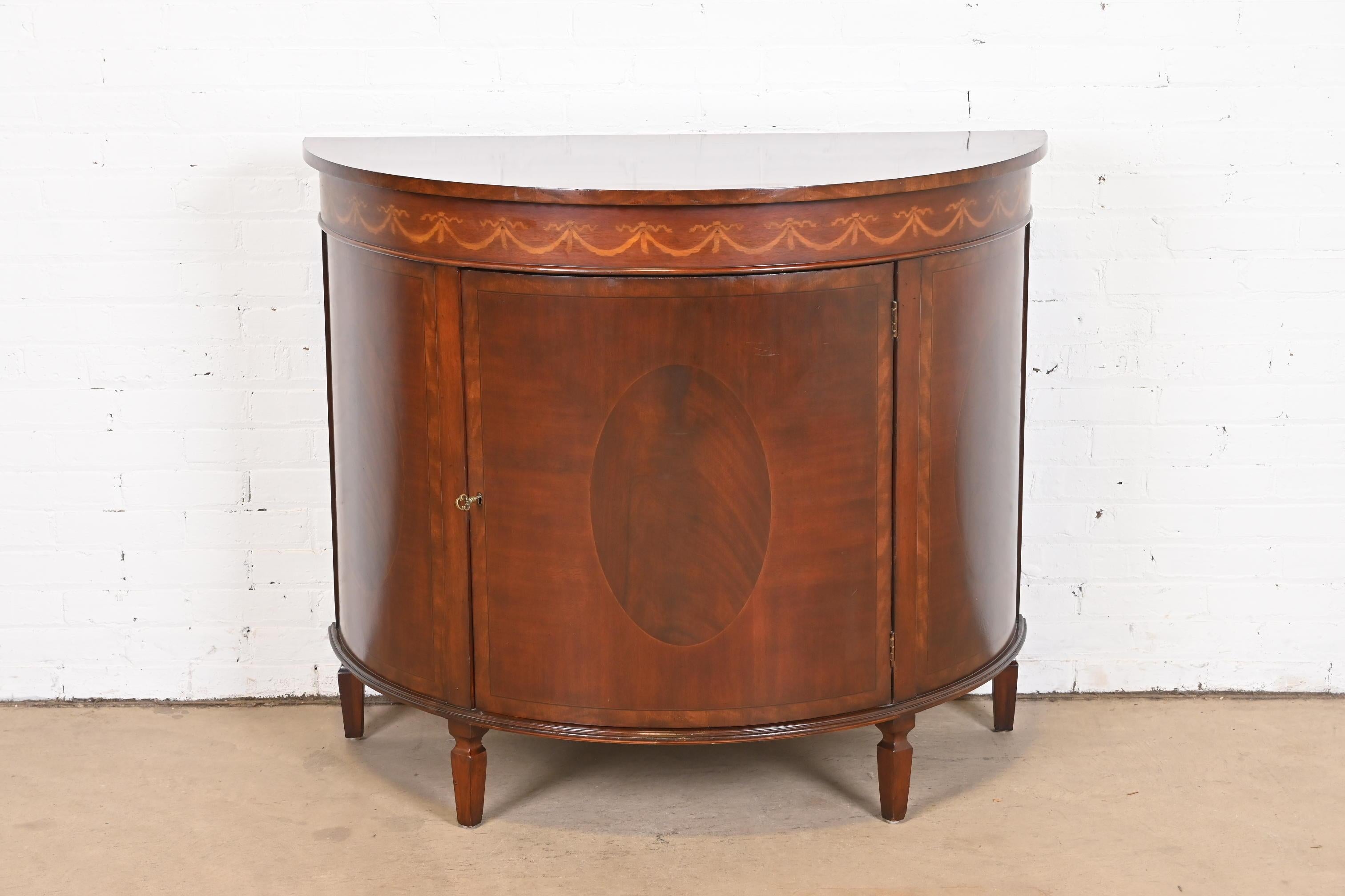 A gorgeous English Georgian or Federal style demilune sideboard, bar cabinet, or console table

In the manner of Baker Furniture 