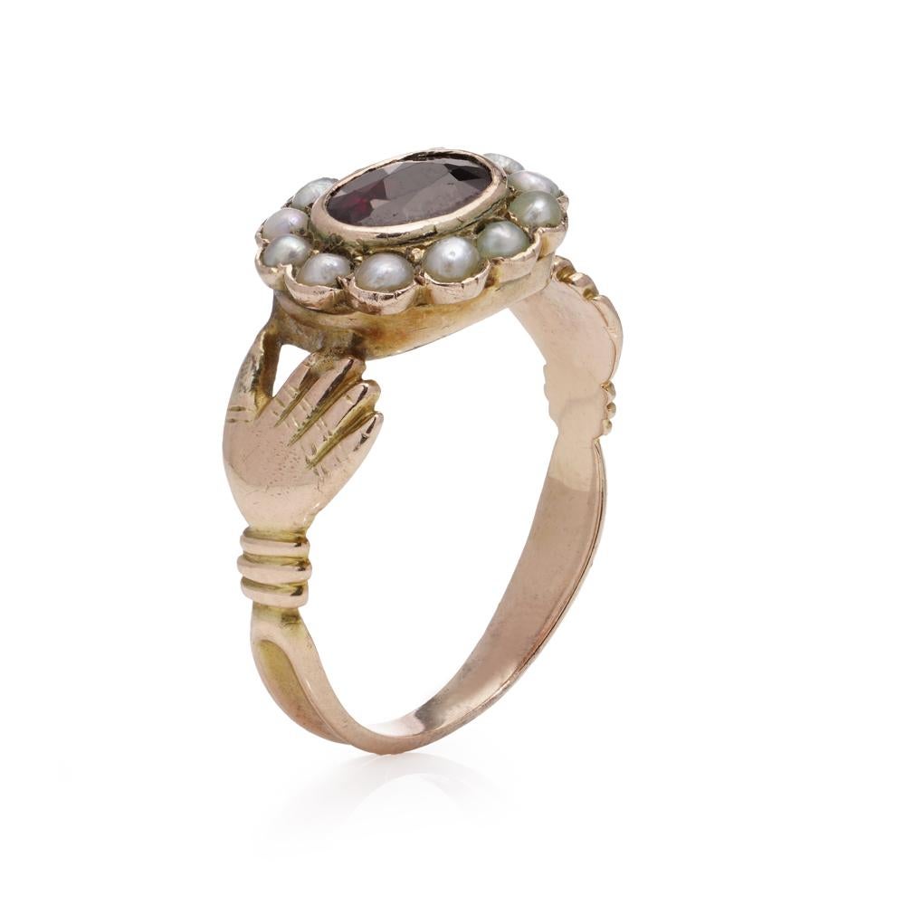 Georgian Fede ring, crafted in 15kt. yellow gold and set with garnet and seed pearls. 
Made in England, Circa 1810's

Item Specifics: 
Dimensions - 
Finger Size: (UK) N 1/2 (EU) = 55.5 (US) = 7.5 
Weight: 3.07 grams

Garnet -
Cut: Oval