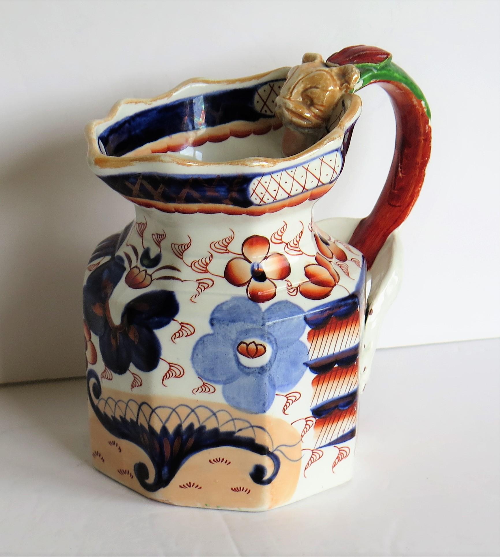 This is a good early 19th century ironstone jug or pitcher, all hand painted and gilded, made by one of the English Staffordshire potteries, circa 1820.

The jug is octagonal in shape with a very good dragon shaped loop handle, very much in the