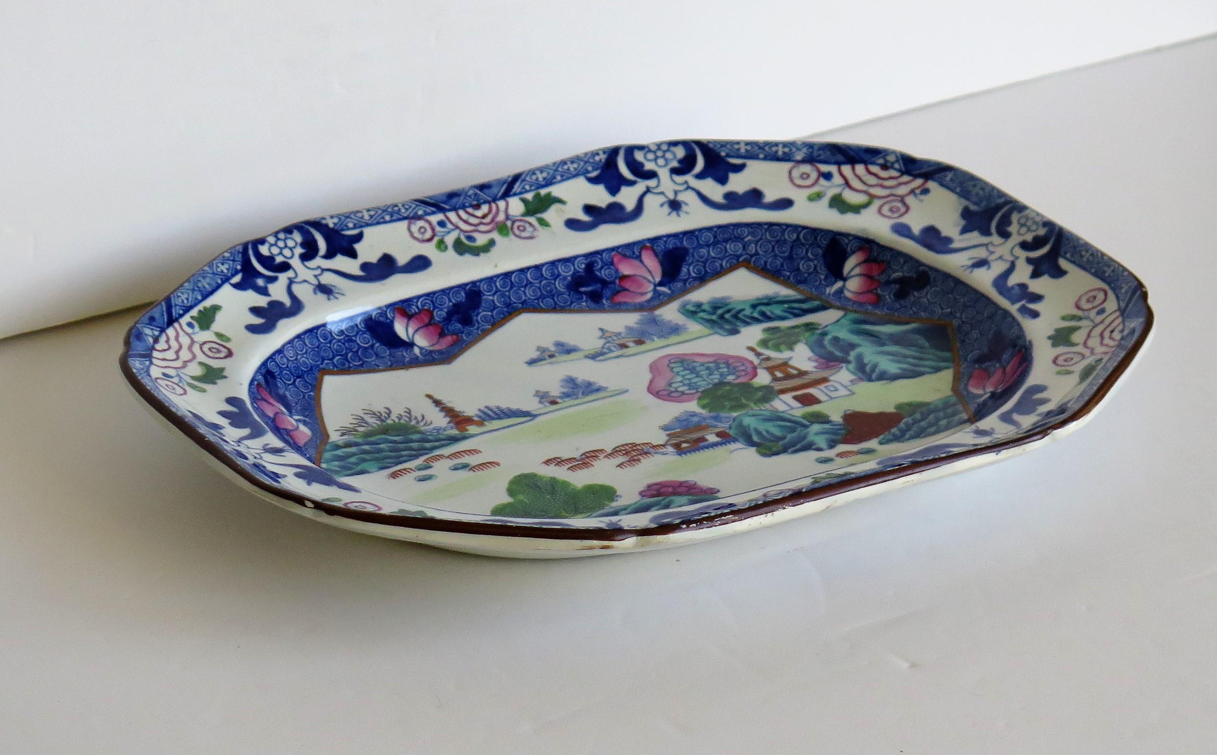 This is a good rounded rectangular Ironstone (stone china) serving platter or plate, in the Chinese Landscape pattern, circa 1818, which we attribute to the factory of Hicks and Meigh of Shelton, Hanley, Staffordshire Potteries, England, who made