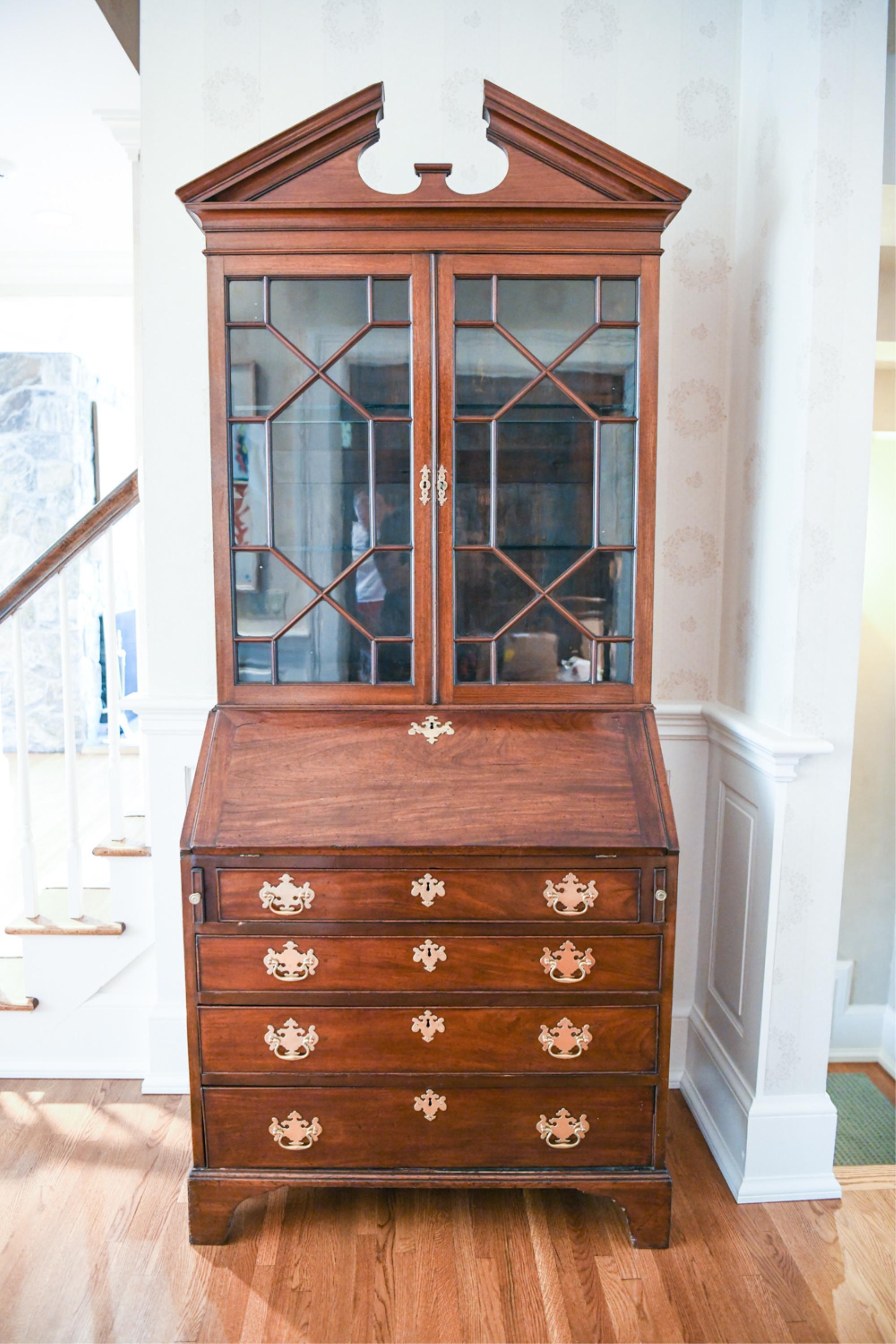 Period George III mahogany secretary bookcase. Chippendale style. Original Glass. Broken arch Pediment top. Great Patina. Of modest size.