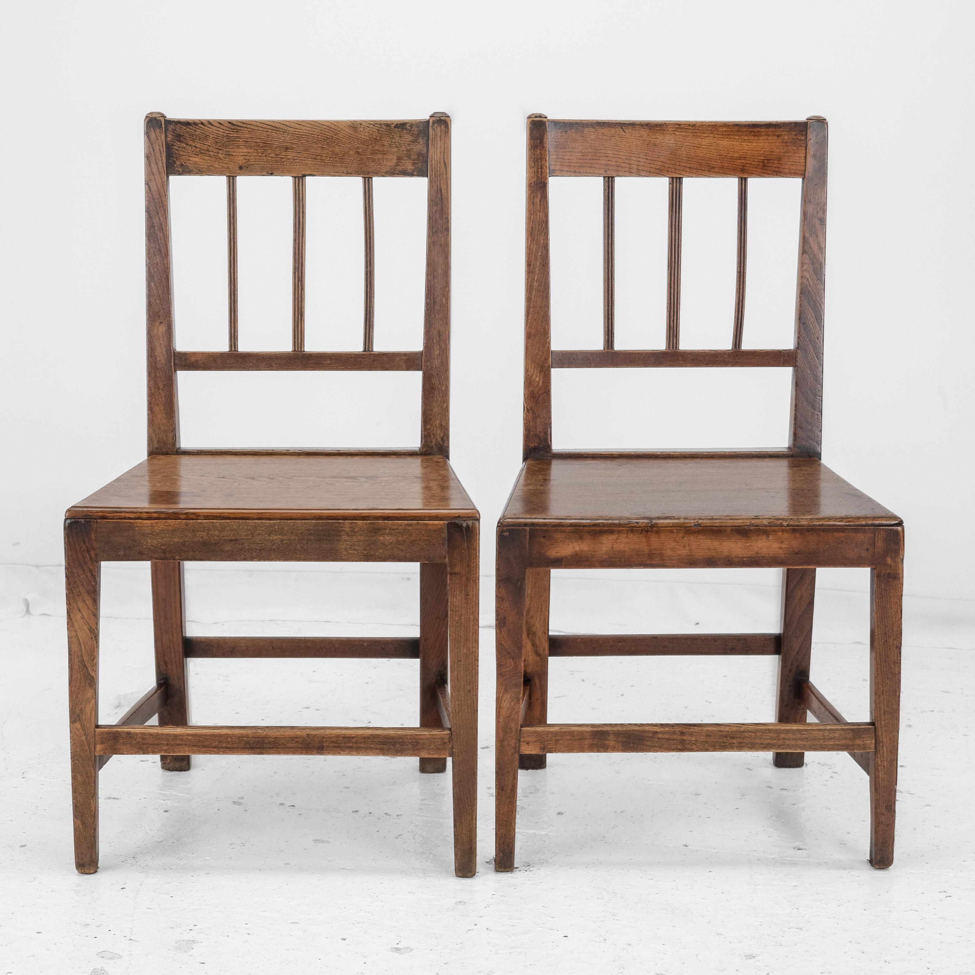 A pair of Georgian period elm and oak country chairs, dating from the late 18th century. Solid elm frames with oak plank seats.

Quality totally original chairs without damages or repairs. Very well presented and ready for use.

Dimensions:

These