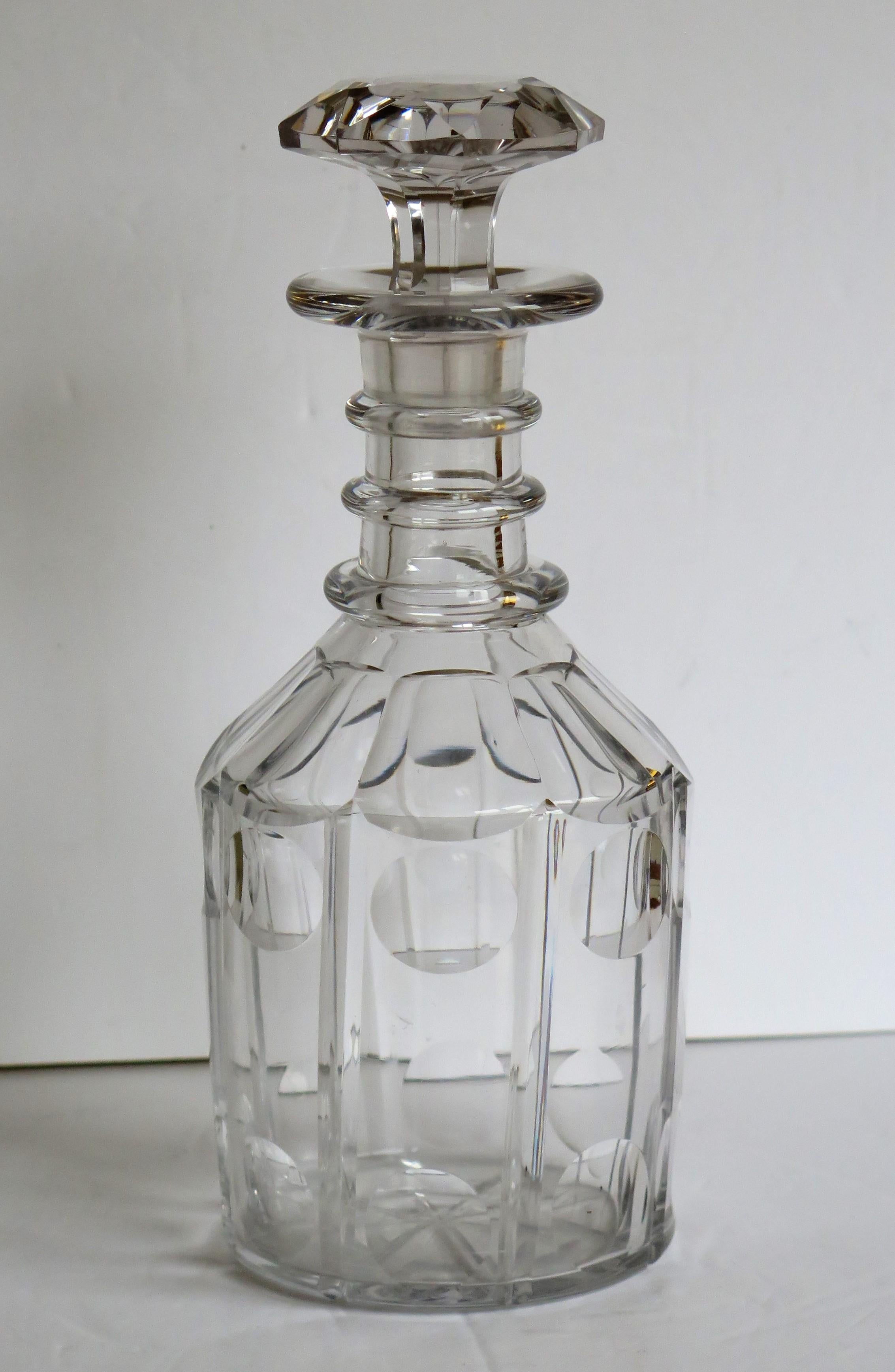 This is a good Anglo-Irish cut-glass or crystal decanter made early in the 19th century, circa 1820, during the English Regency, late Georgian period.

The decanter is nominally straight sided and is beautifully cut in eight vertical columns or