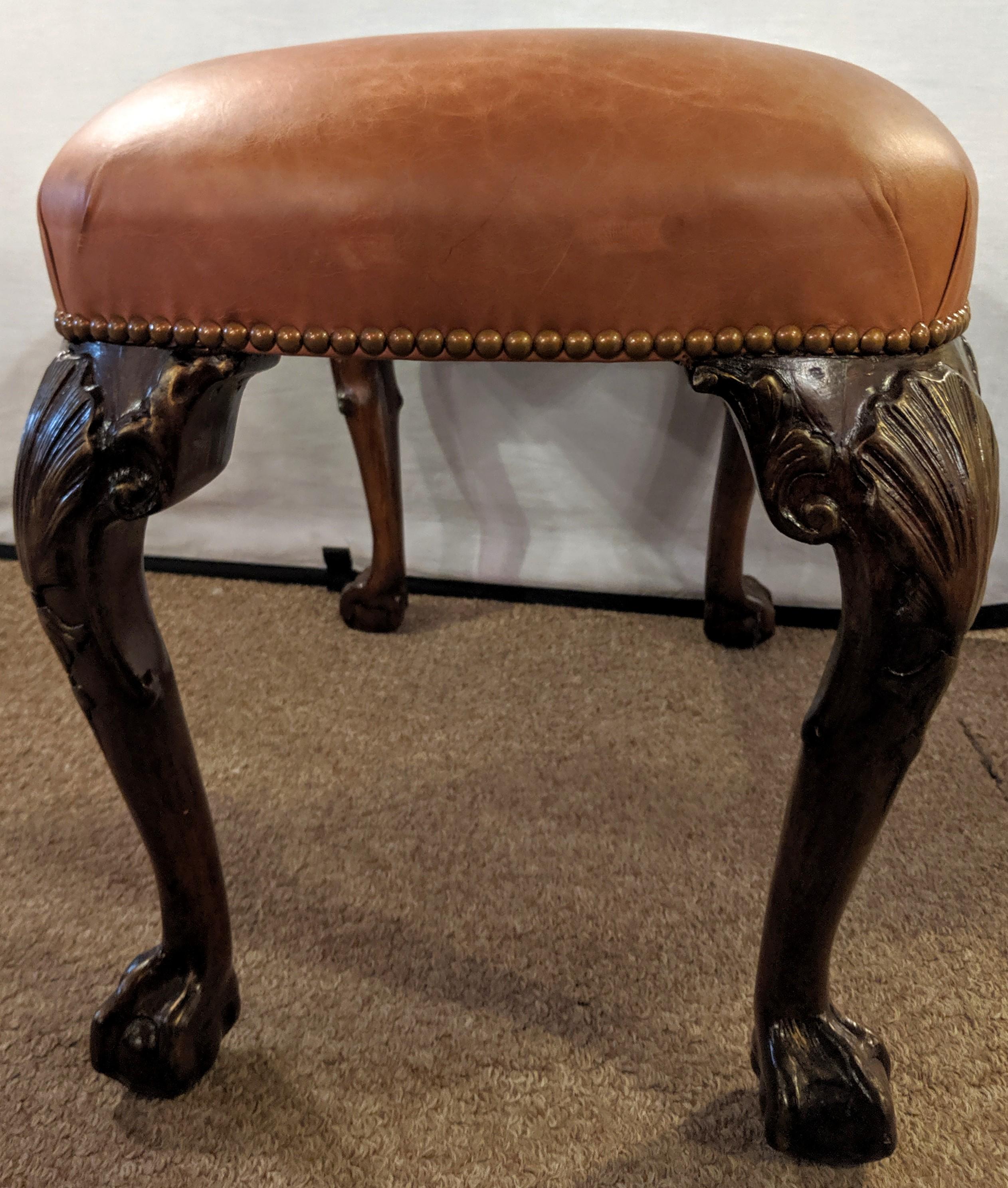 Georgian leather ball and claw foot stool or bench having a wonderfully detailed cabriole leg and hairy ball and claw foot.