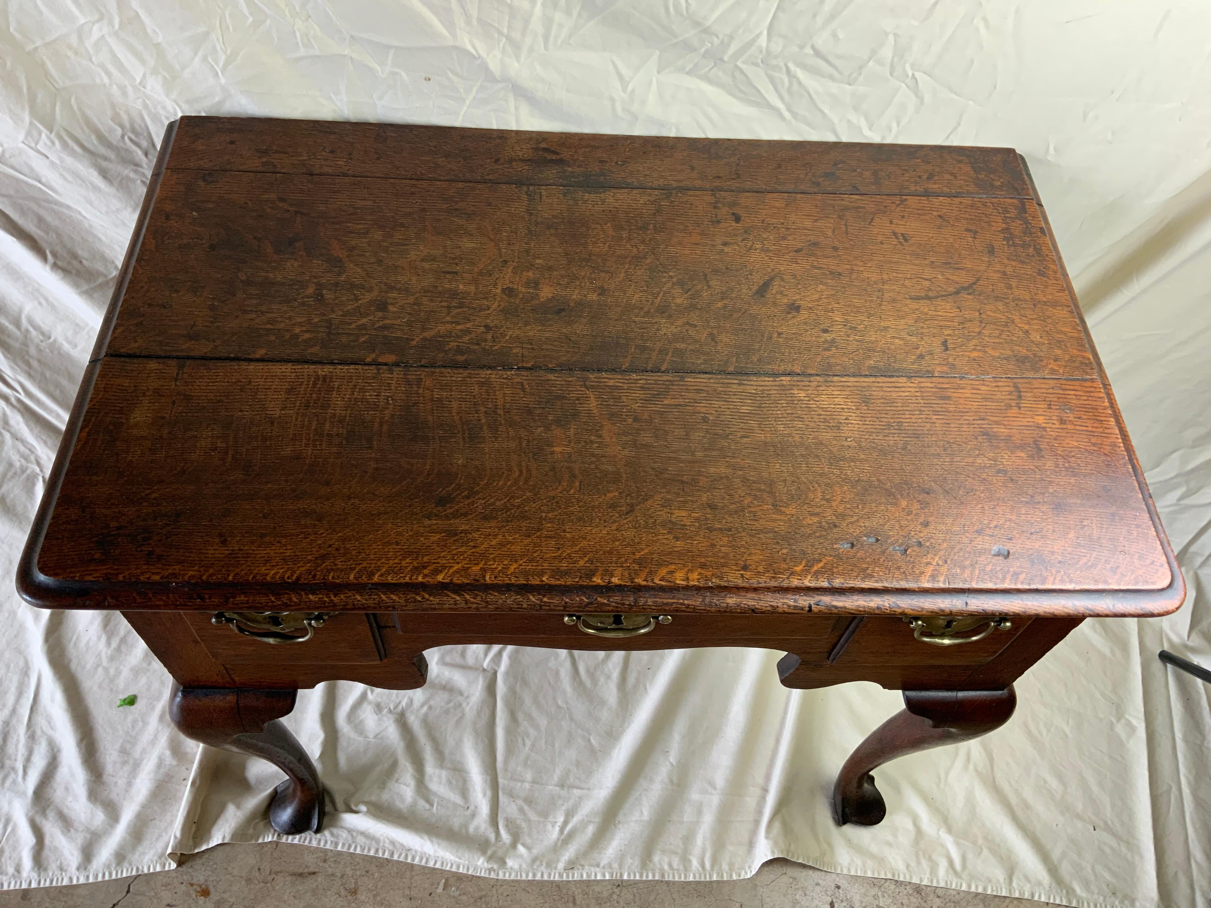 ate 18th Century Georgian Oak Lowboy 1780-90. This George III Period Oak Low Boy has a beautifully moulded top above three drawers with molded edges. Nicely shaped apron above four cabriole legs with trifid or drake feet. Original brasses and an old