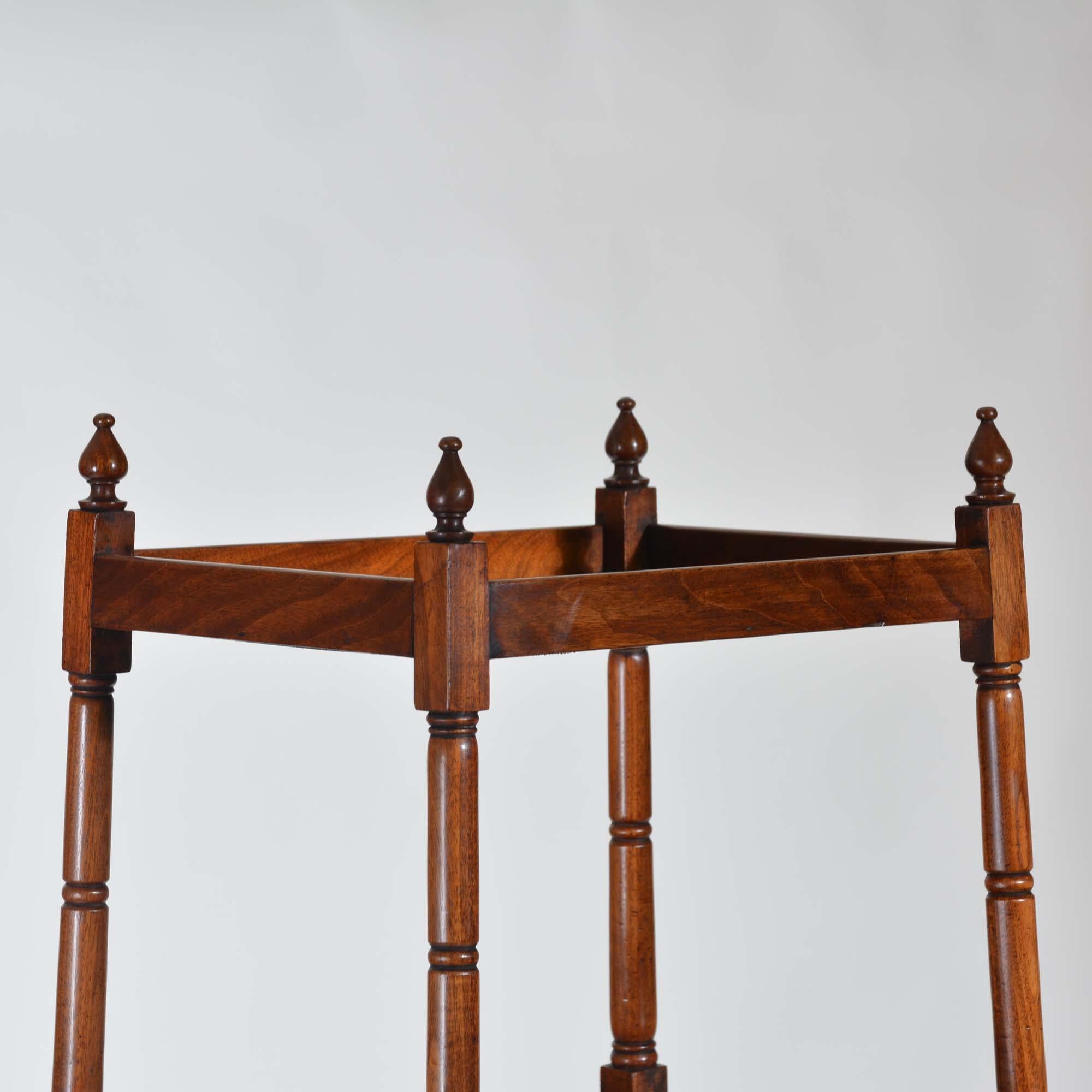 Georgian mahogany A-frame whatnot

A fine George III mahogany graduated A-frame whatnot, the four graduated tiers with three trays, the lower shelf with drawer below. Ring turned column supports with fine turned finials.
English, circa 1800

150cm