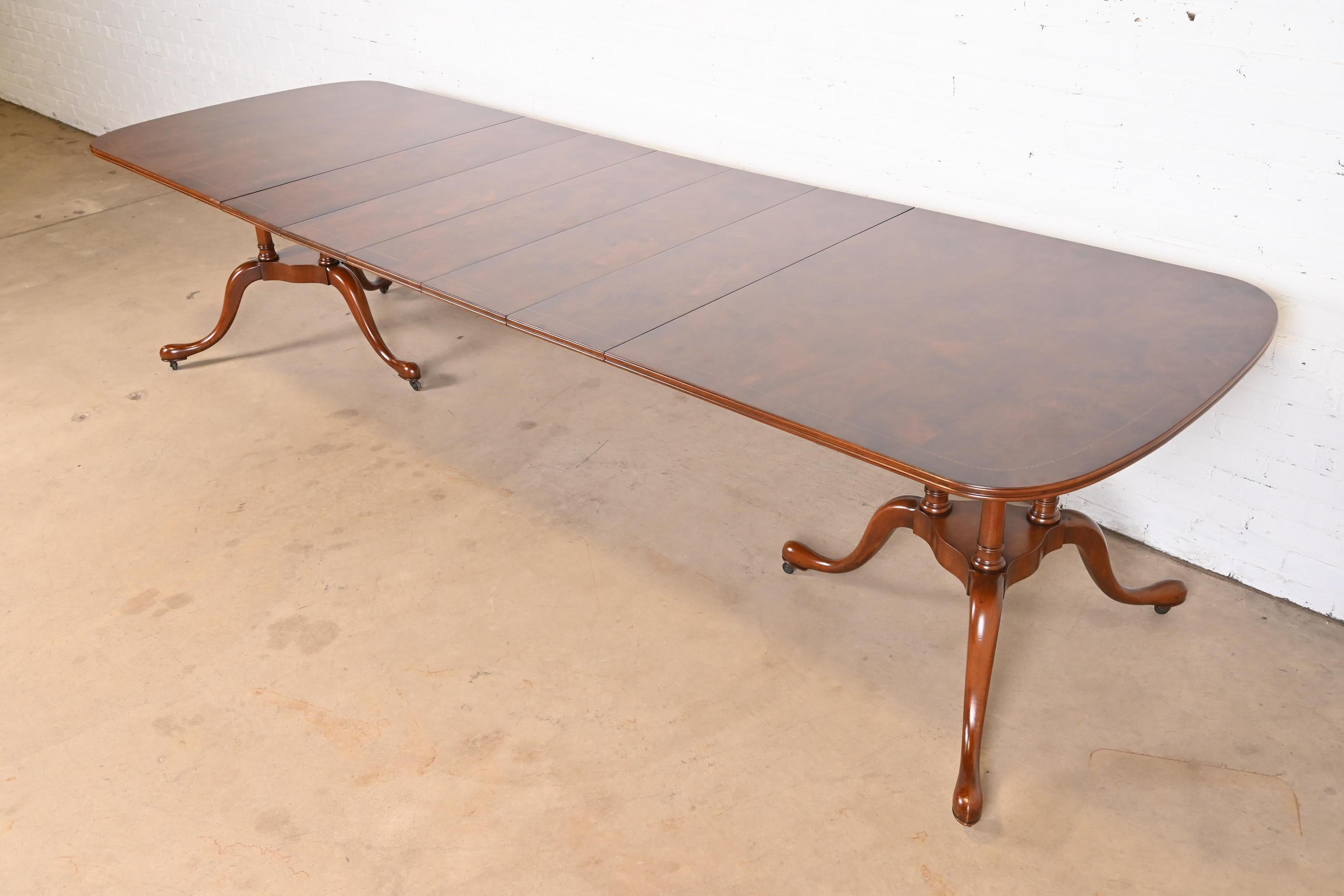 An exceptional Georgian, Chippendale, or Queen Anne style double pedestal extension dining table

By Robert W. Irwin Co.

USA, Circa 1940s

Stunning carved mahogany and burl wood top, with solid mahogany pedestals on casters.

Measures: 71.75