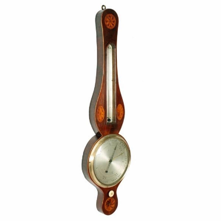 A late 18th to early 19th century Georgian mahogany cased 8 inch dial barometer & thermometer.

The case has a box wood edge and is decorated with oval and round inlaid fans.

The silvered dial has the barometric measurements and has 'James,
