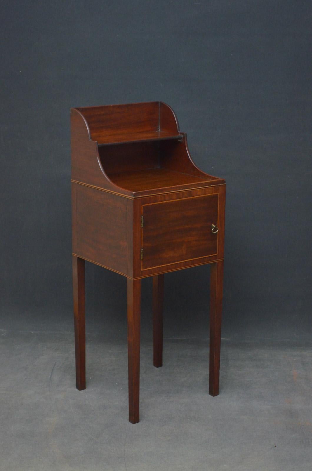 Sn4564, George III mahogany pot cupboard with shaped upstand and a shelf to top and string inlaid cupboard door fitted with brass handles, all standing on substantial square legs. 
This antique bedside cabinet retains its original finish which has